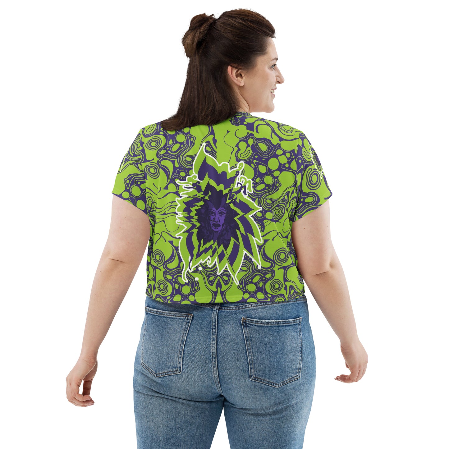 A model wearing green and purple crop tee from Kloe Store featuring bold abstract patterns and a unique central artistic face design, perfect for a trendy and edgy streetwear style.