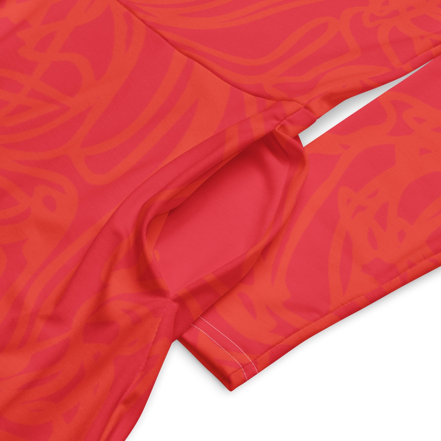 Red dress with vibrant swirl details and mirrored face design on the back, inspired by cultural art and bold self-expression.