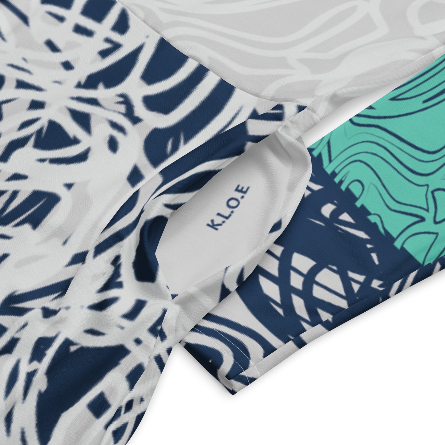 Long sleeve midi dress with full-body abstract print in navy and jade, featuring hand-drawn mirrored faces and layered spiral motifs—designed to express standout individuality.
