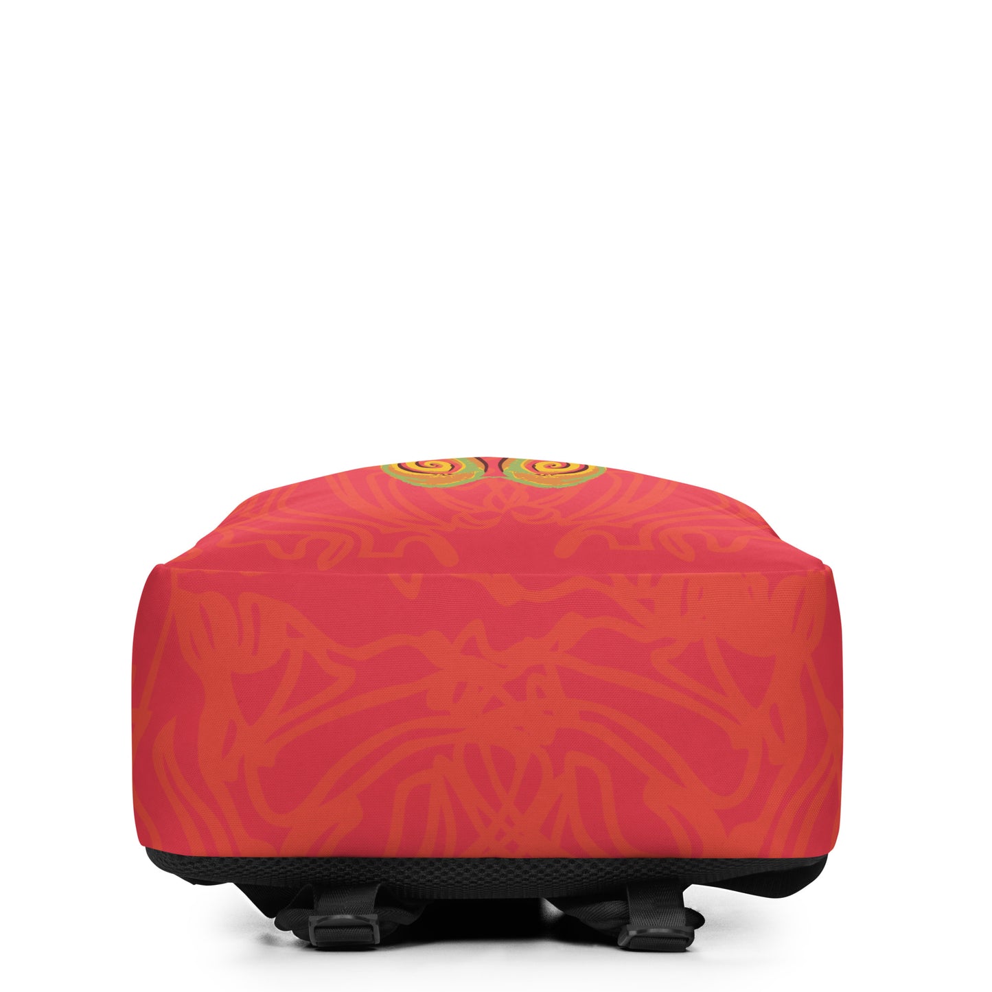 Red-orange backpack with mirrored face design and vibrant spiral patterns, inspired by cultural artistry and self-expression.