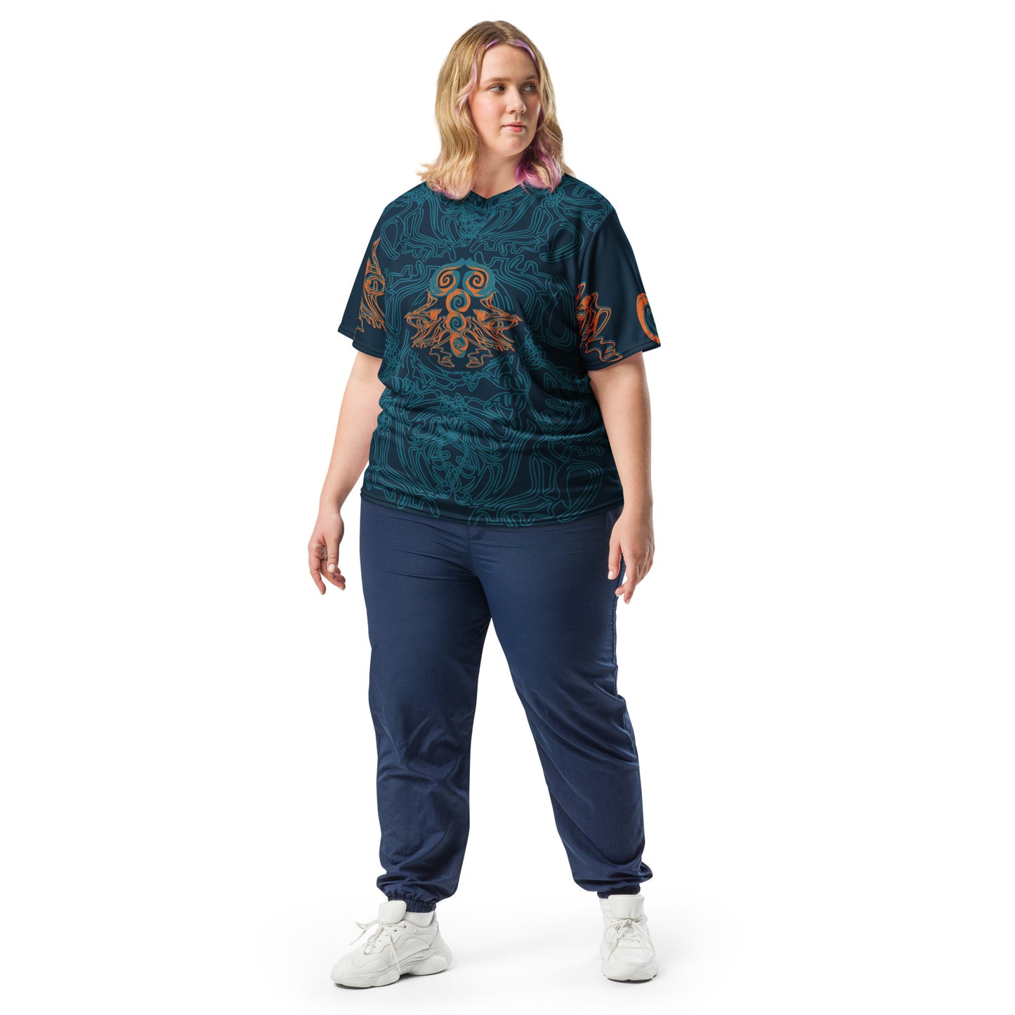 Front view of a navy blue sports jersey featuring intricate cyan line art and bold orange tribal-inspired patterns, with a mirrored abstract design at the center, on a model.