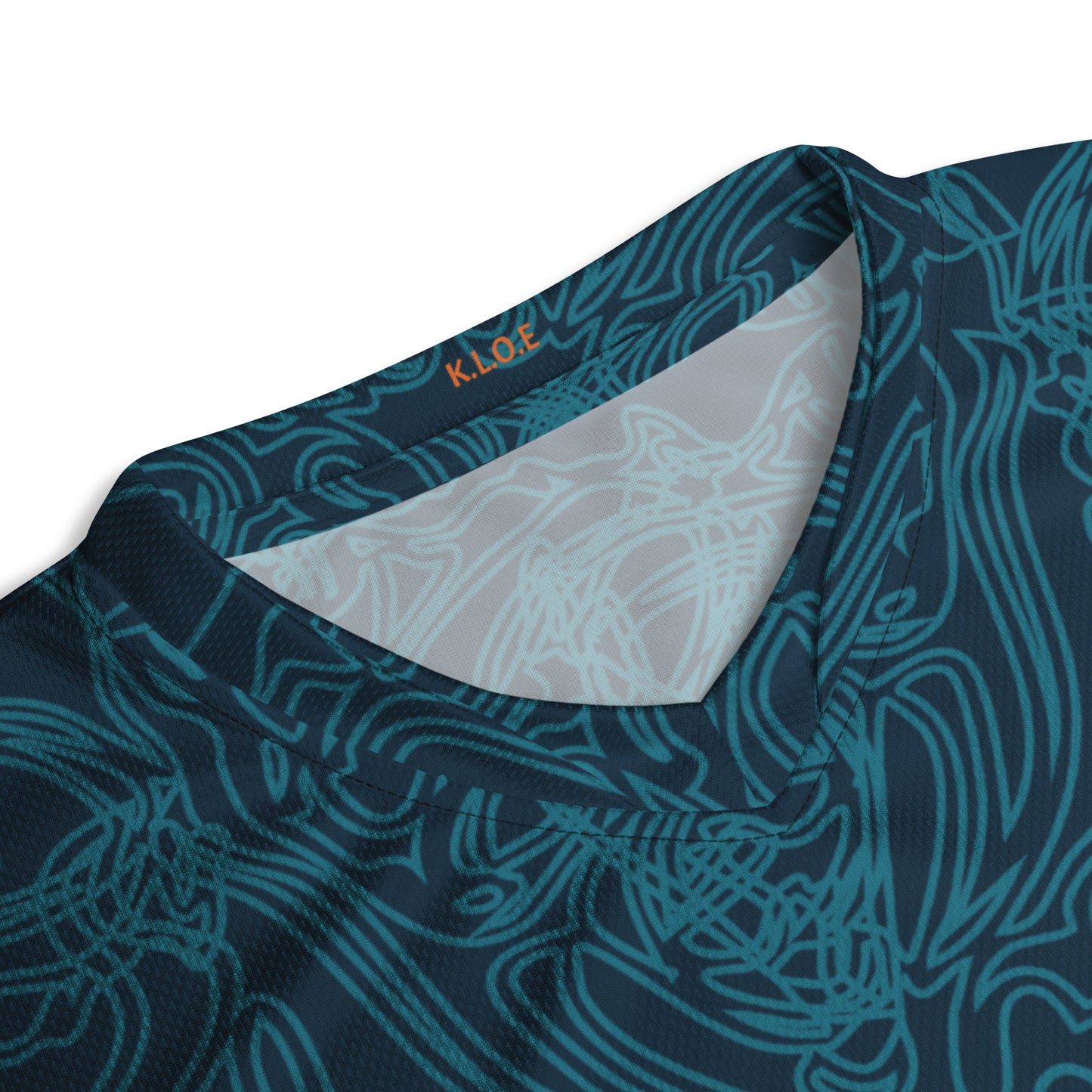 Neck view of a navy blue sports jersey featuring intricate cyan line art and bold orange tribal-inspired patterns.