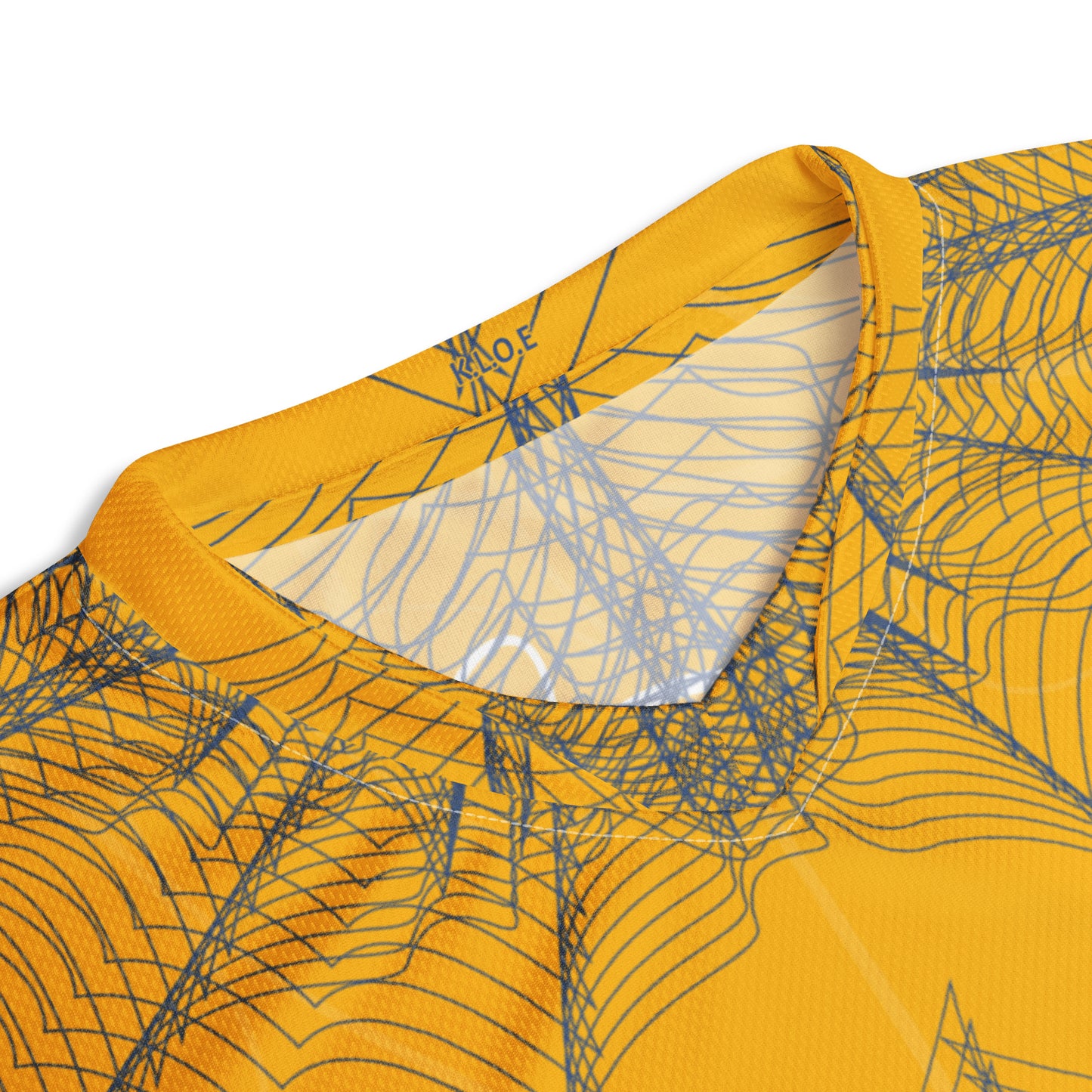 Front view of a golden yellow sports jersey featuring intricate navy web-like linework and a bold mirrored face design at the center, blending hand-drawn art with streetwear energy, showing details around the neckline.