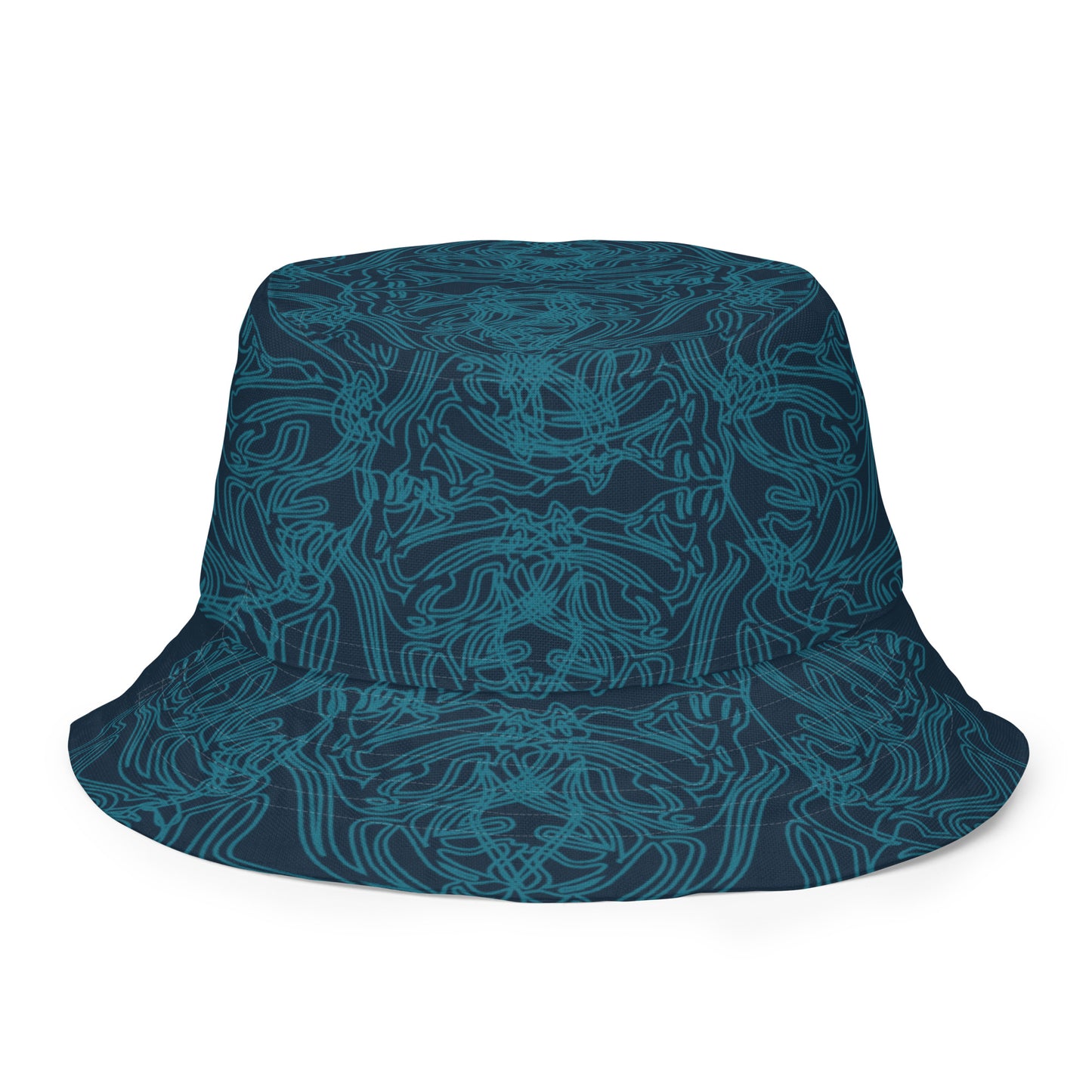 Reversible bucket hat with a navy blue base and intricate cyan linework, featuring an abstract, artistic pattern, worn by a model.