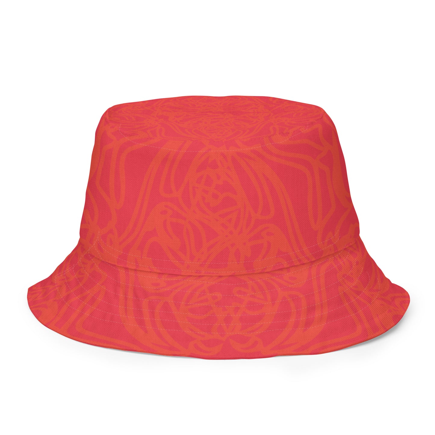 Reversible red-orange bucket hat with cultural swirl design and mirrored face motif on one side, and K.L.O.E wordmark on the other.