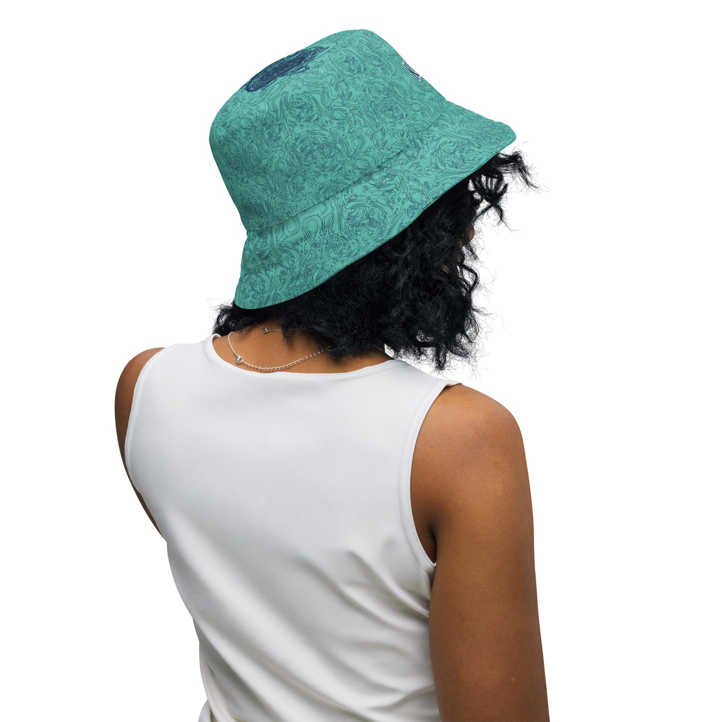 Reversible bucket hat with abstract jade and white linework, featuring dual-face artwork on one side and K.L.O.E logo on the other—crafted for bold, expressive style.