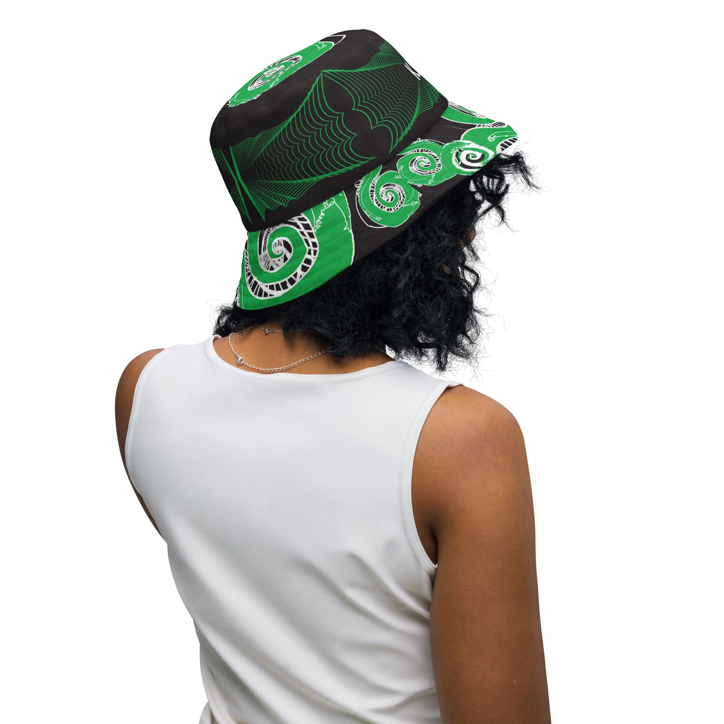 Hand-illustrated reversible bucket hat featuring bold green spirals and intricate web-inspired patterns — crafted for versatile self-expression and rooted in artistic individuality, exclusive to KLOE.
