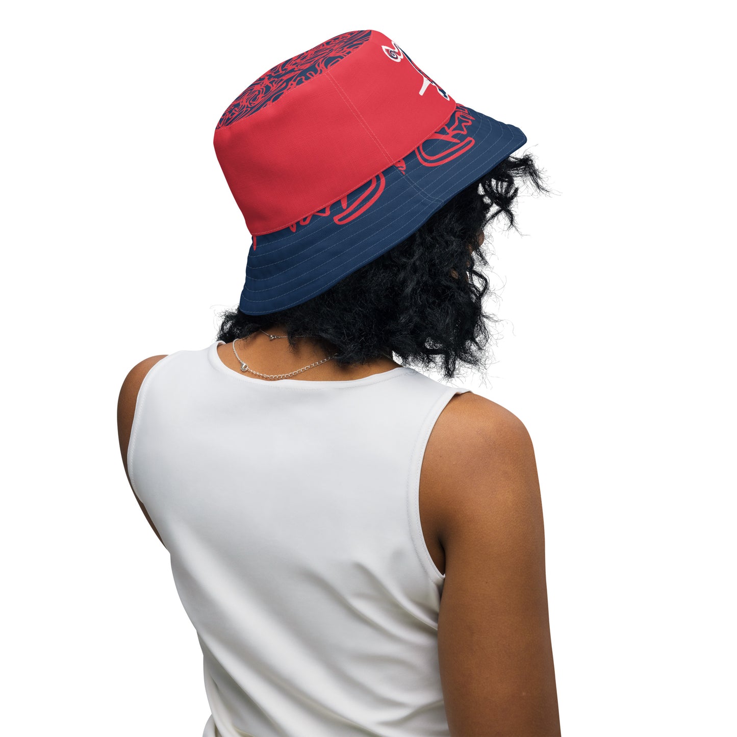 Bold reversible streetwear bucket hat featuring hand-drawn tribal patterns on one side and a mirrored face design on the other, crafted in navy and red for an edgy, modern look – KLOE fashion.