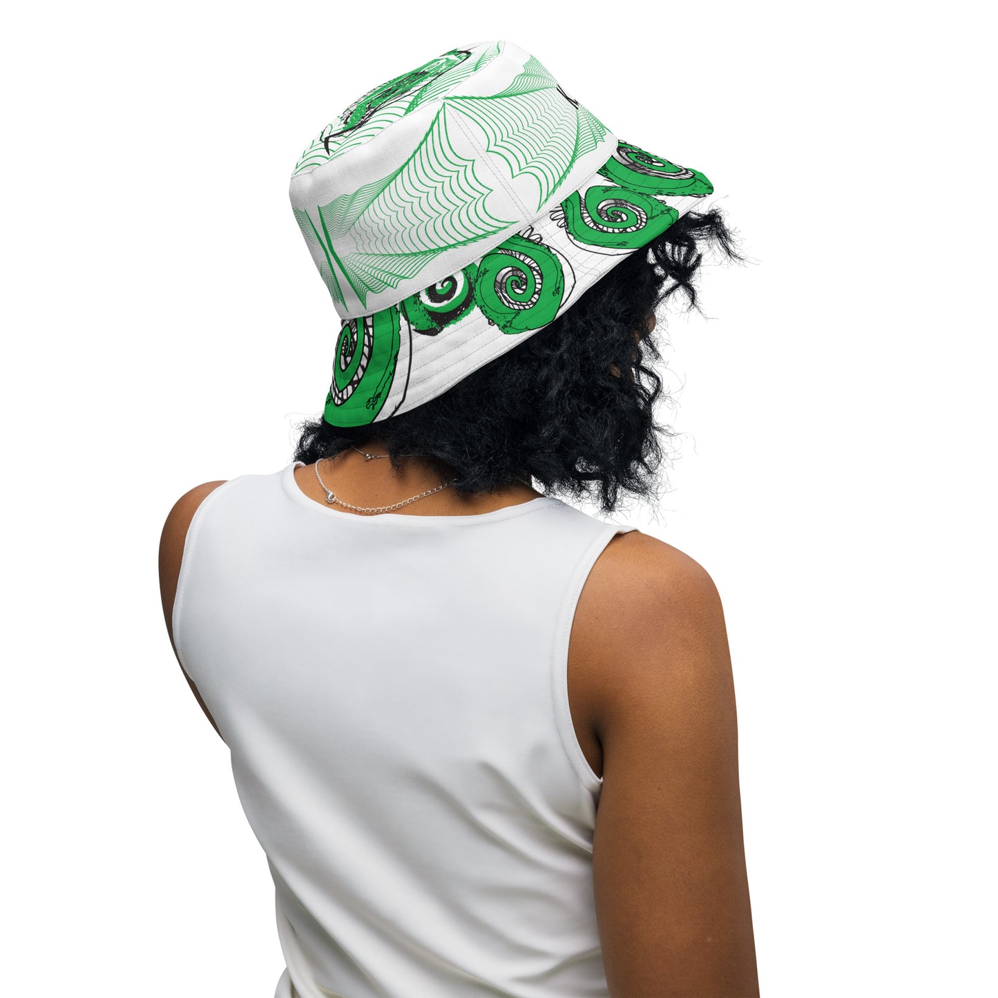 Hand-illustrated reversible bucket hat featuring bold green spirals and intricate web-inspired patterns — crafted for versatile self-expression and rooted in artistic individuality, exclusive to KLOE.