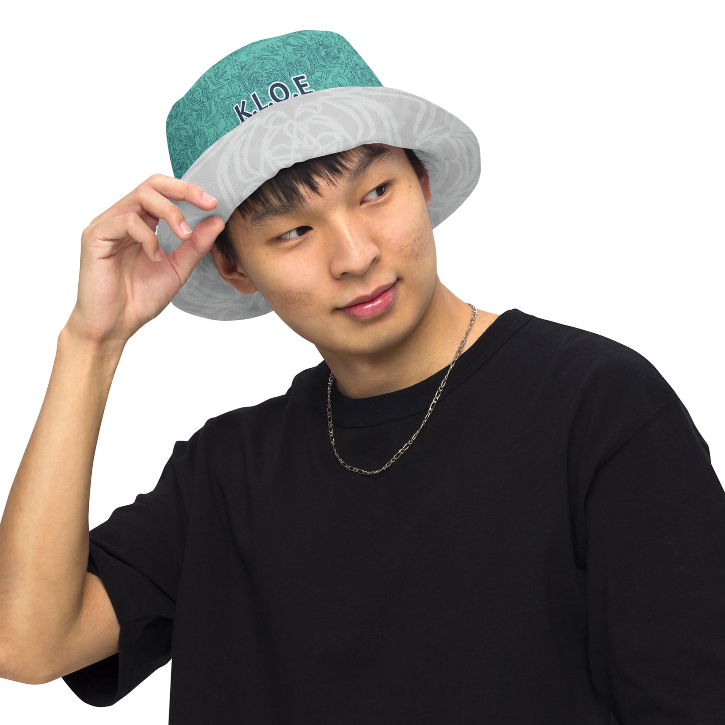 Reversible bucket hat with abstract jade and white linework, featuring dual-face artwork on one side and K.L.O.E logo on the other—crafted for bold, expressive style.