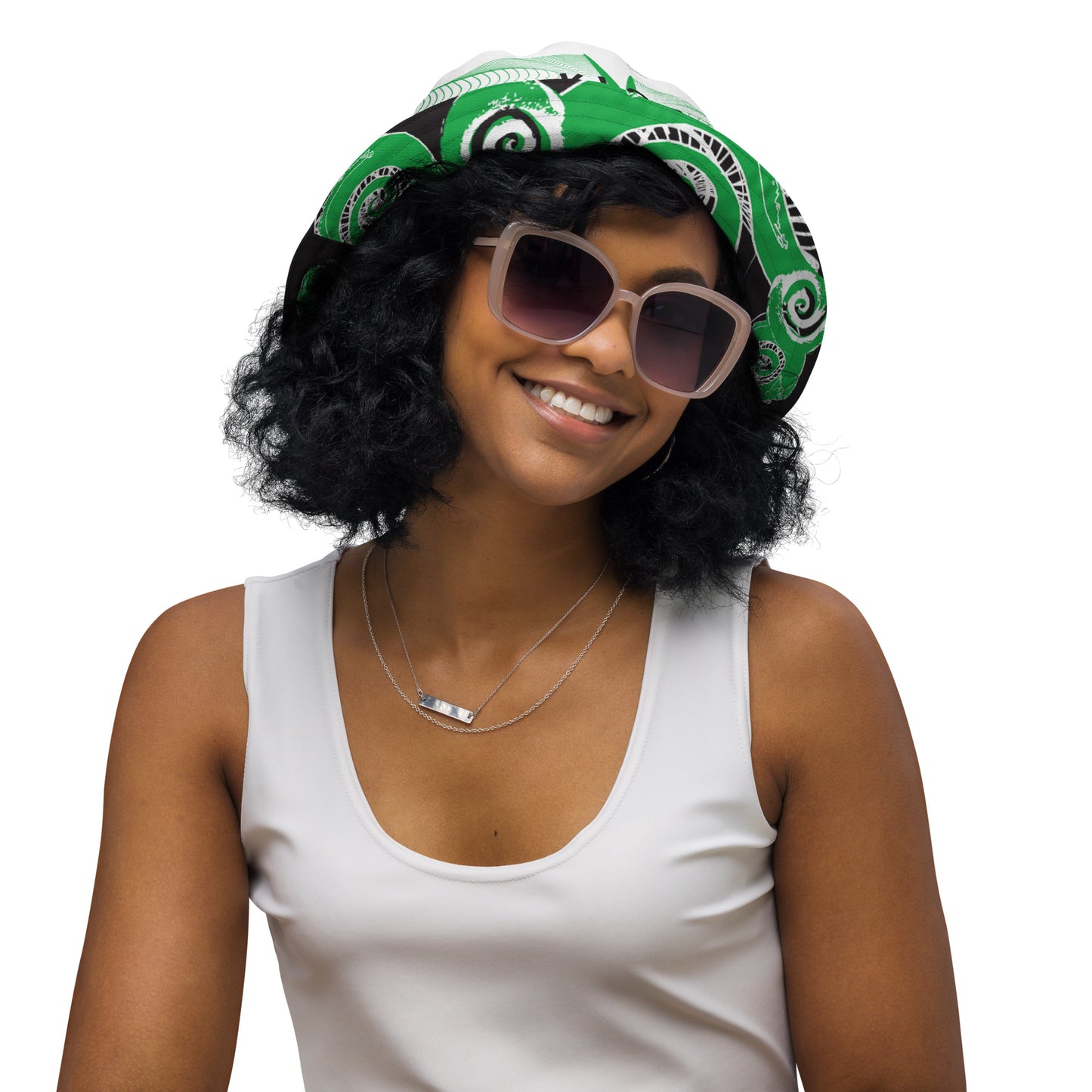 Hand-illustrated reversible bucket hat featuring bold green spirals and intricate web-inspired patterns — crafted for versatile self-expression and rooted in artistic individuality, exclusive to KLOE.