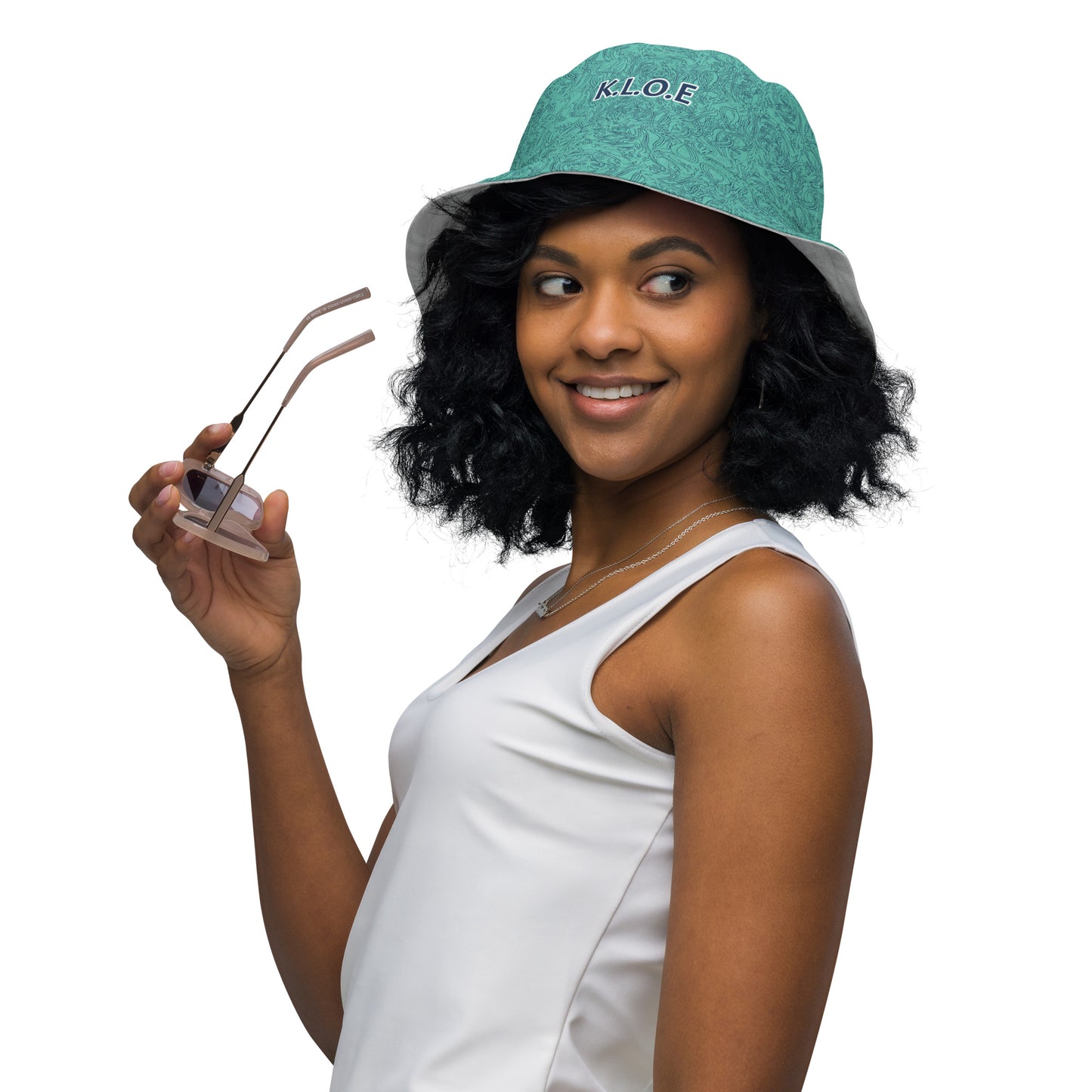 Reversible bucket hat with abstract jade and white linework, featuring dual-face artwork on one side and K.L.O.E logo on the other—crafted for bold, expressive style.