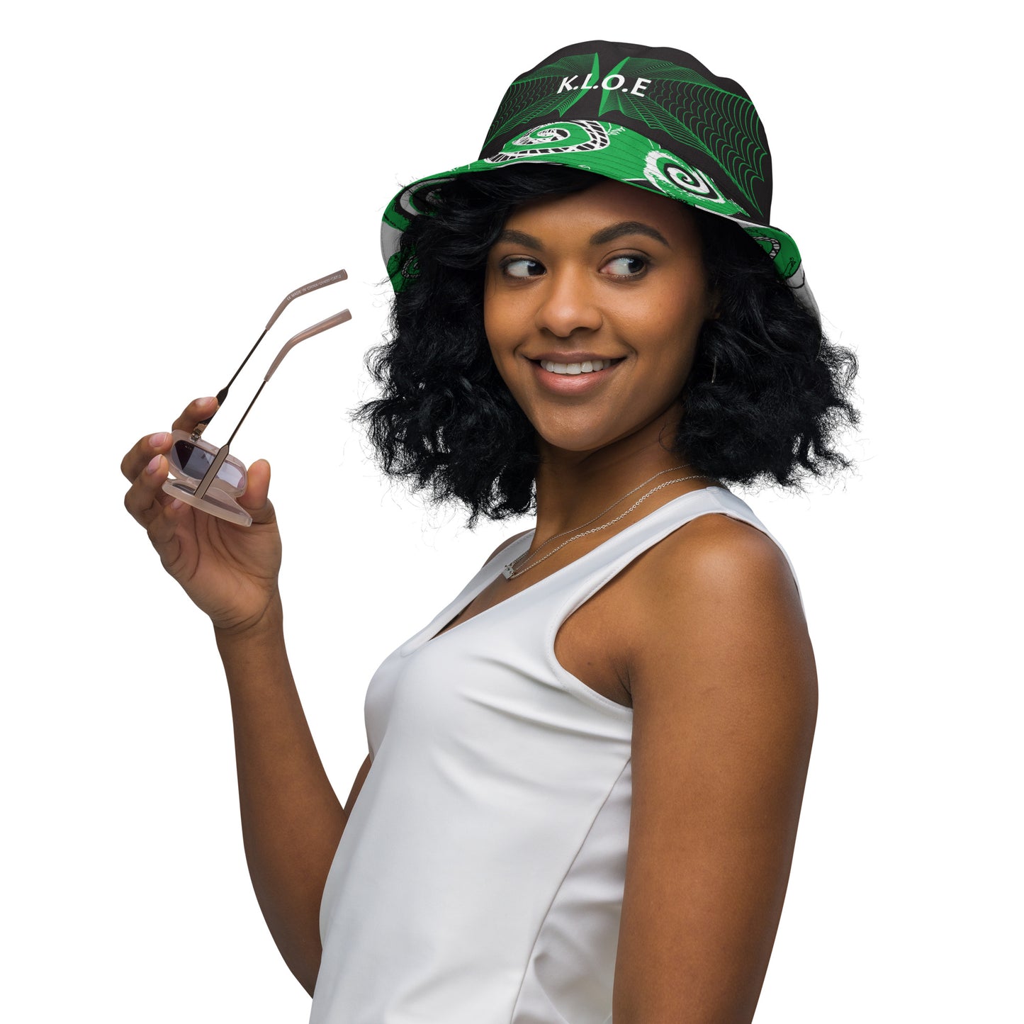 Hand-illustrated reversible bucket hat featuring bold green spirals and intricate web-inspired patterns — crafted for versatile self-expression and rooted in artistic individuality, exclusive to KLOE.