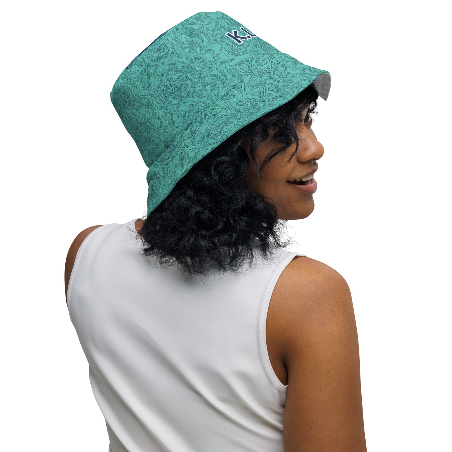 Reversible bucket hat with abstract jade and white linework, featuring dual-face artwork on one side and K.L.O.E logo on the other—crafted for bold, expressive style.