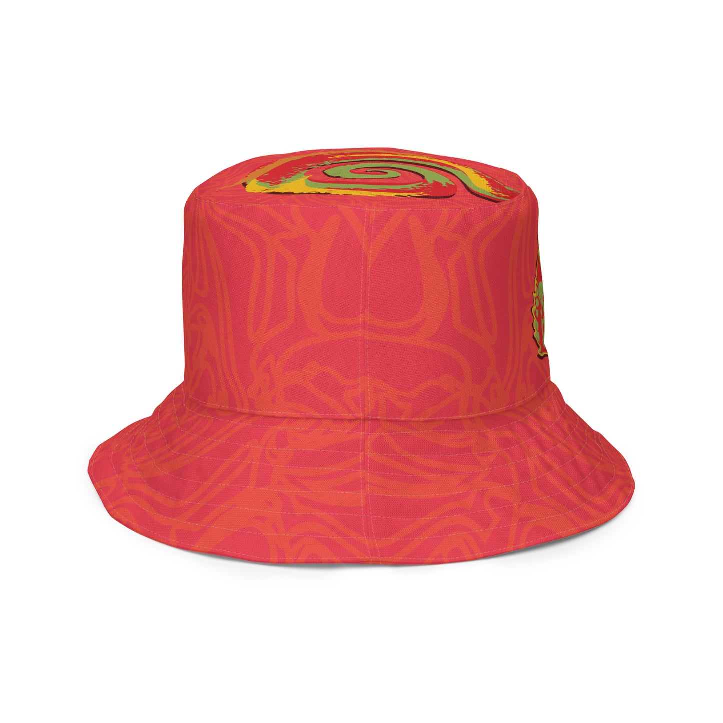Reversible red-orange bucket hat with cultural swirl design and mirrored face motif on one side, and K.L.O.E wordmark on the other.