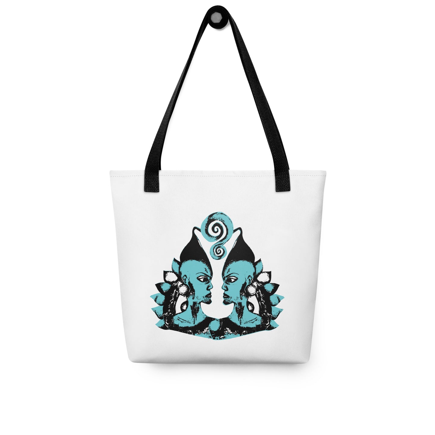 White tote bag with a bold K.L.O.E. hand-drawn design featuring two mirrored faces in black and teal, highlighting cultural inspiration, individuality, and modern bohemian self-expression.