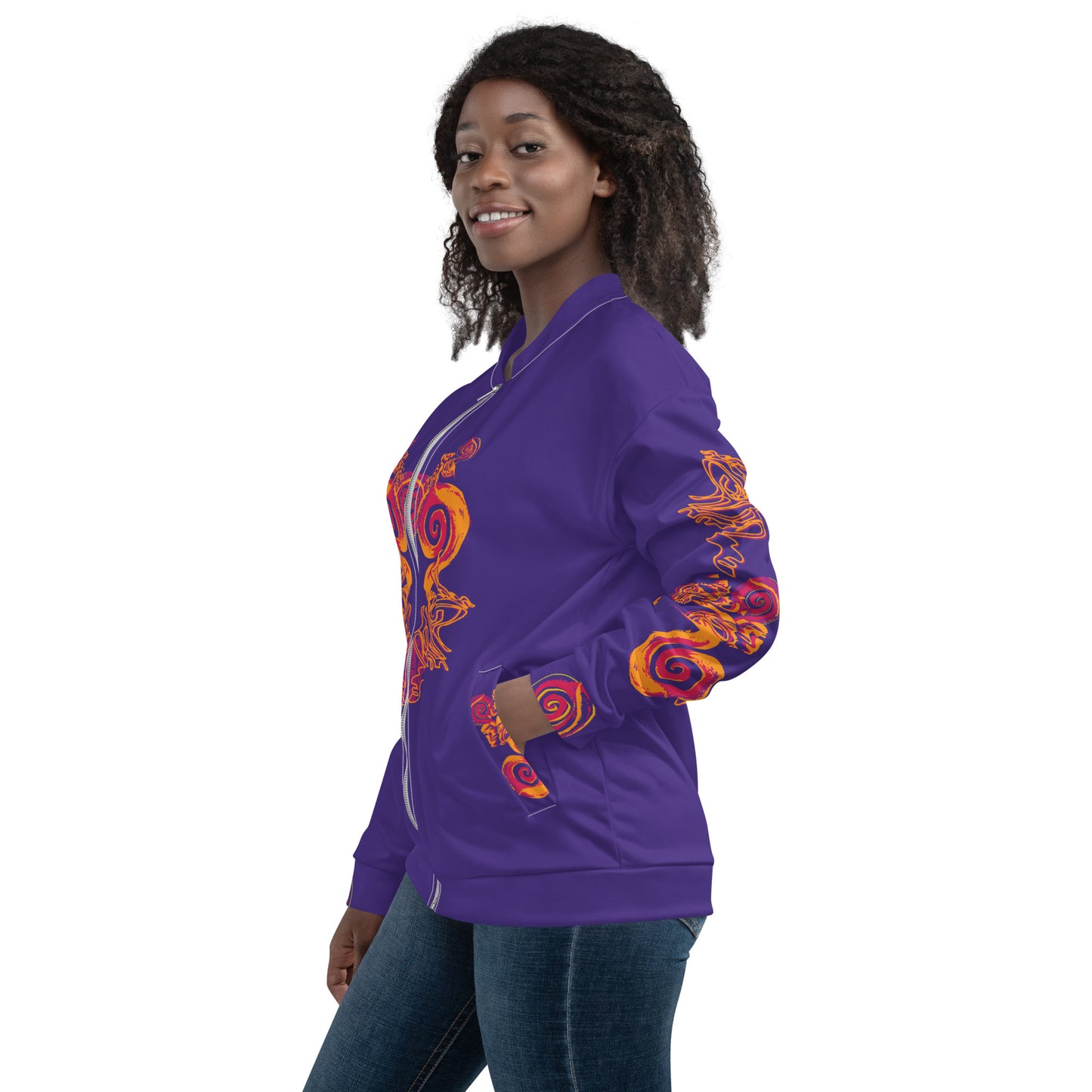 Bold purple bomber jacket with vibrant orange and red culturally inspired patterns, featuring mirrored face design and swirling motifs — expressive fashion from KLOE’s The Secret Chambers of I & I collection, on a model.