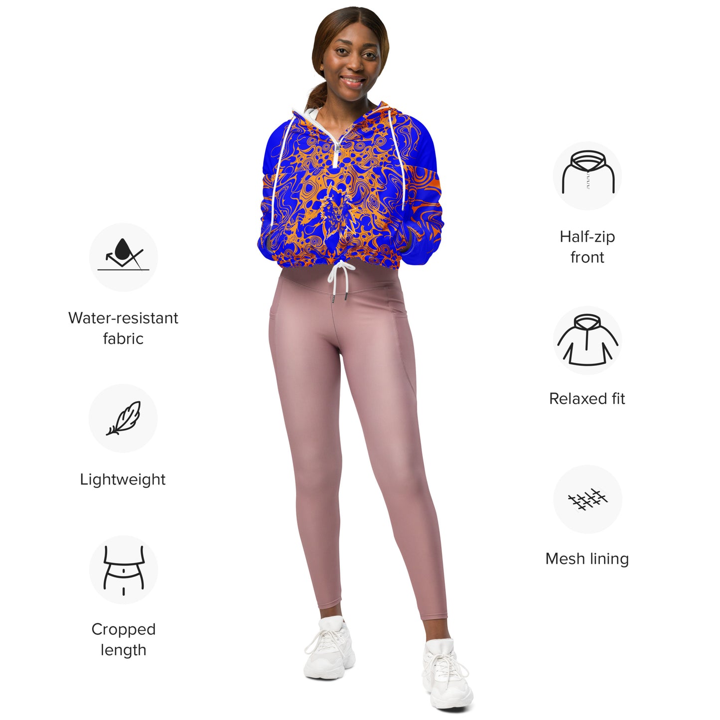 Product mockup - model wearing a vibrant blue and orange cropped windbreaker from Kloe Store featuring abstract swirl pattern, a front zipper, drawstring hood, and elastic cuffs, offering a stylish and modern streetwear look.