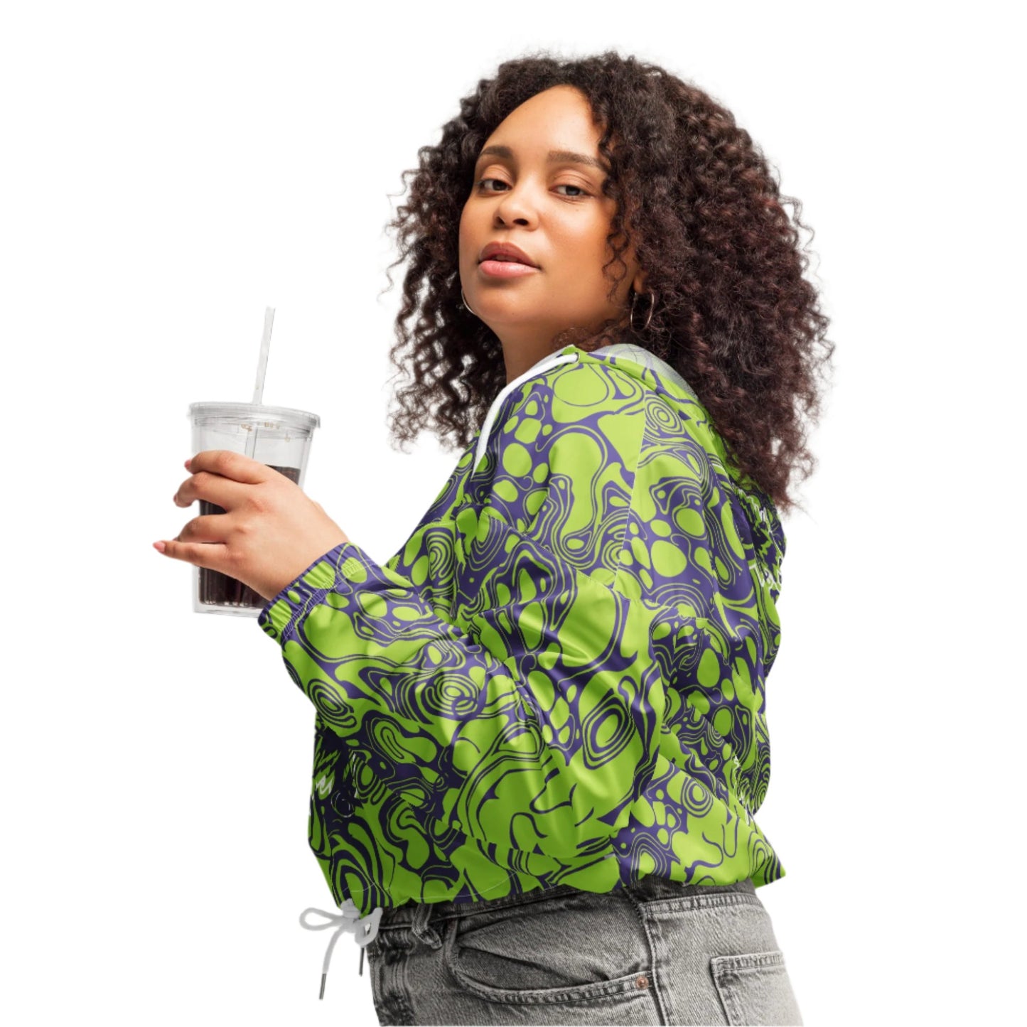 The model wearing green and purple cropped windbreaker from Kloe Store featuring bold abstract patterns and a unique artistic face design, ideal for a trendy streetwear look.
