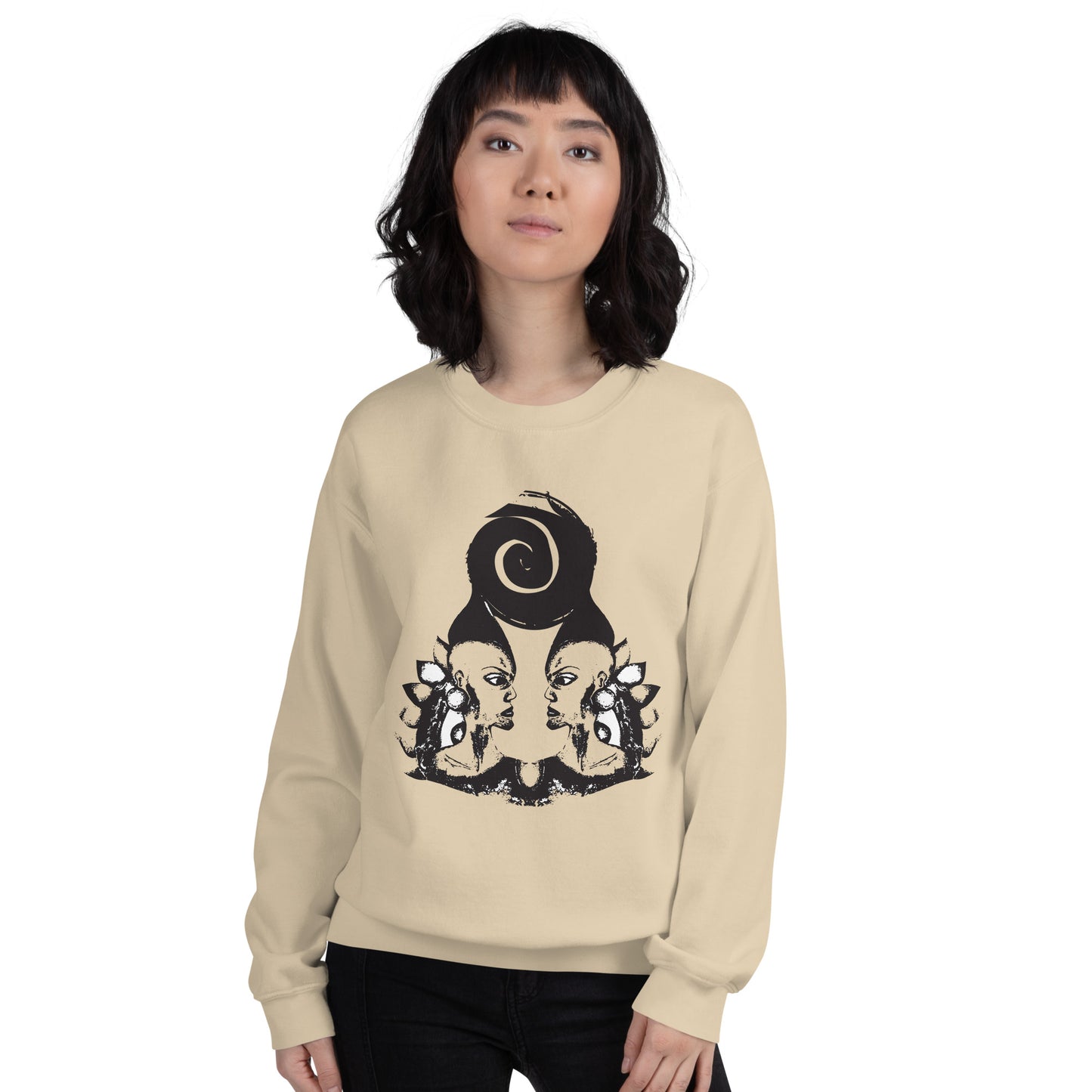 A model wearing sand color K.L.O.E. sweatshirt featuring a culturally inspired, hand-drawn design of two mirrored faces in bold black, showcasing unique artistry and self-expression in modern bohemian style clothing.