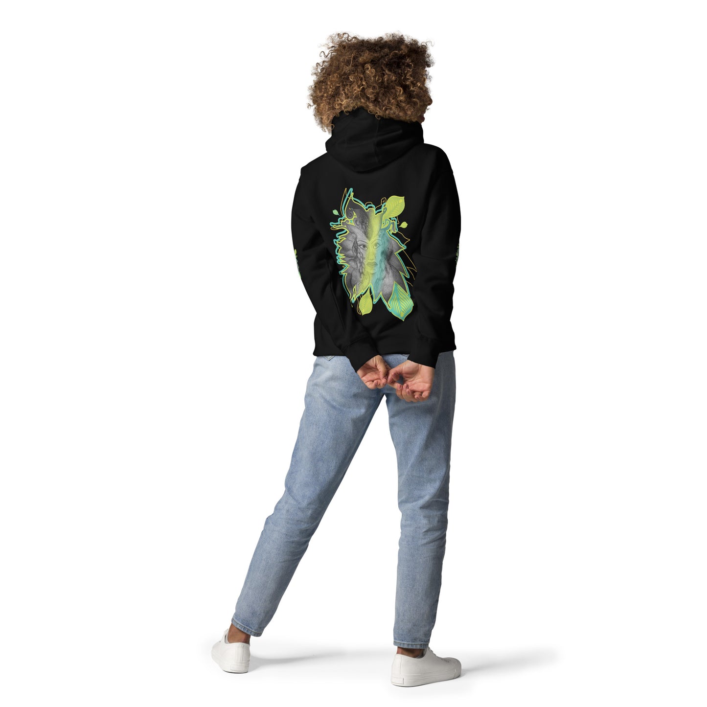 Back view of K.L.O.E. black hoodie featuring a bold hand-drawn face design framed by vibrant green and yellow leaf patterns. A statement of modern bohemian style, artistic craftsmanship, and self-expression that celebrates individuality and culturally inspired fashion, on a model.