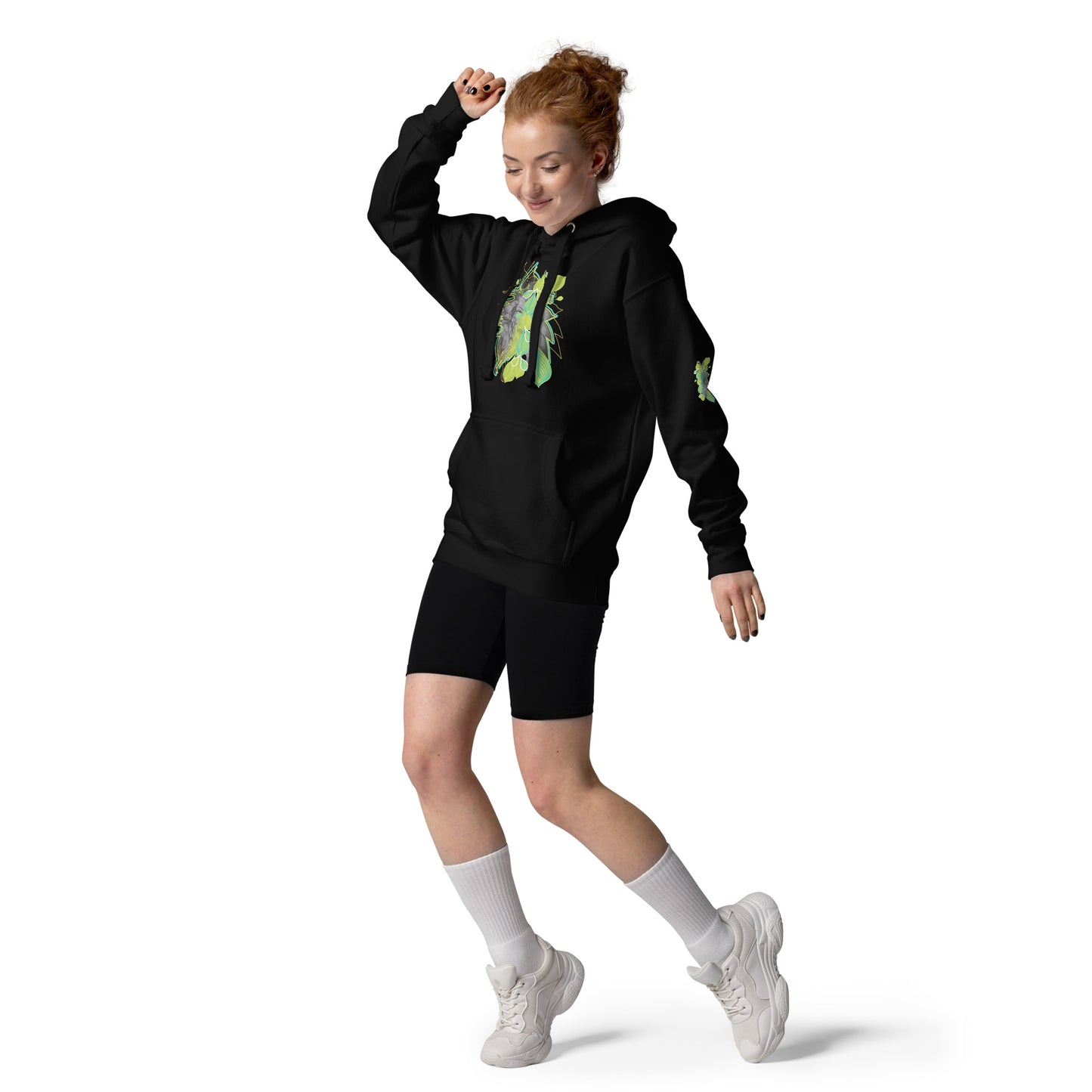 Front view of black K.L.O.E. hoodie with vibrant green and yellow leaf patterns framing a detailed hand-drawn face design. A modern bohemian style statement that celebrates individuality, artistic expression, and culturally inspired fashion, on a model.