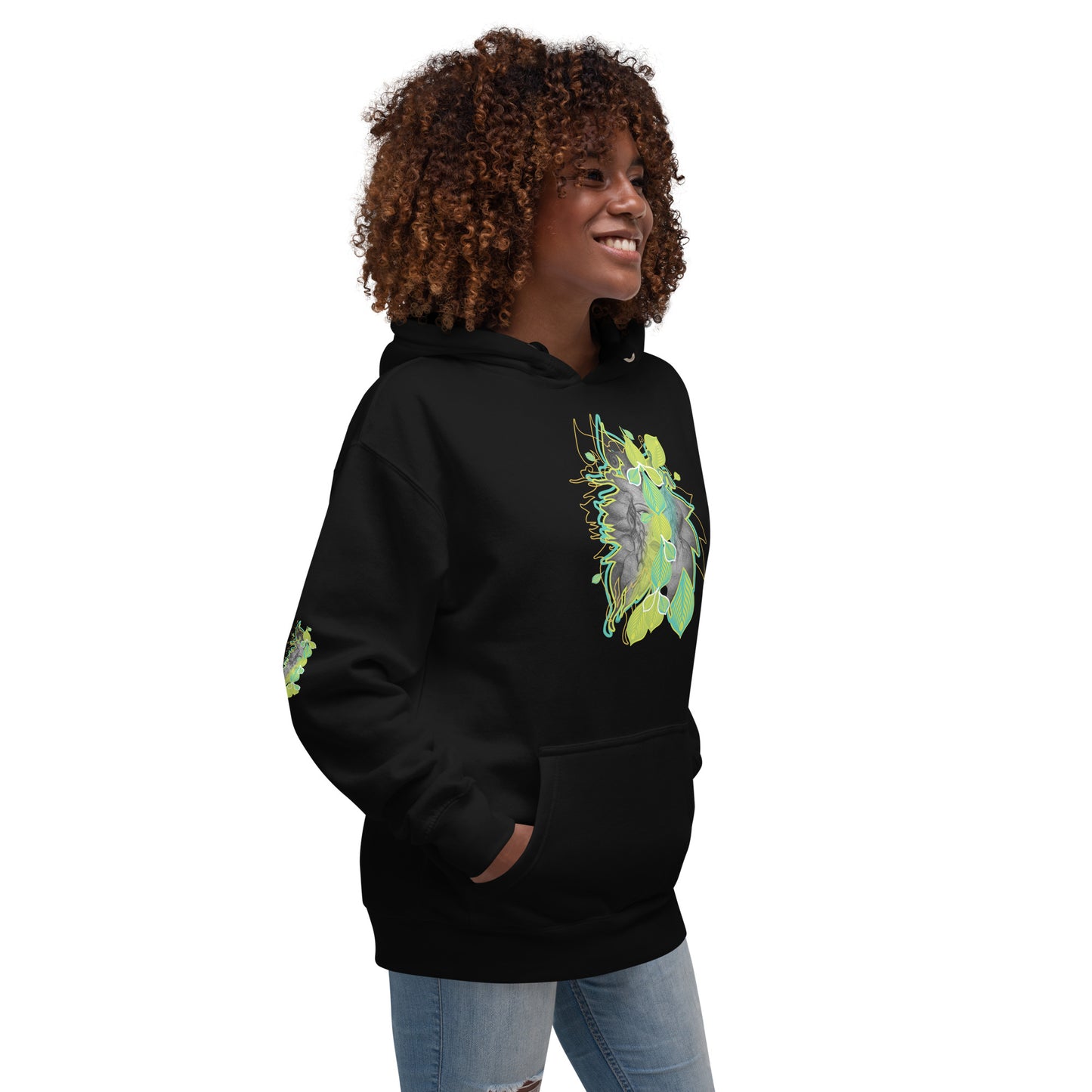 Side view of black K.L.O.E. hoodie with vibrant green and yellow leaf patterns framing a detailed hand-drawn face design. A modern bohemian style statement that celebrates individuality, artistic expression, and culturally inspired fashion.
