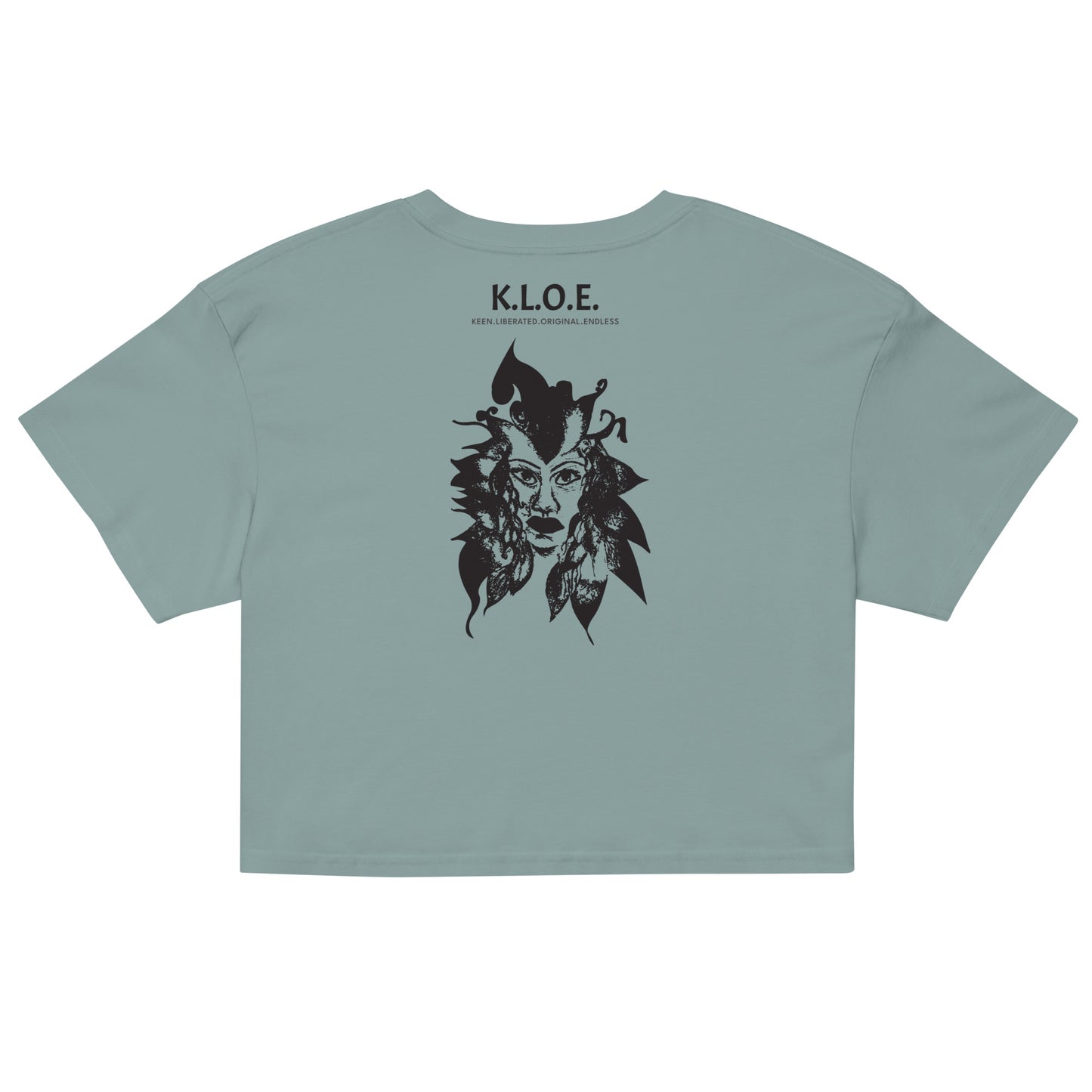 Back view of a mineral K.L.O.E. crop t-shirt showcasing a culturally inspired, hand-drawn black design featuring a bold, expressive face intertwined with flowing, abstract patterns, and K.L.O.E. logo, embodying artistic self-expression and modern bohemian style fashion.