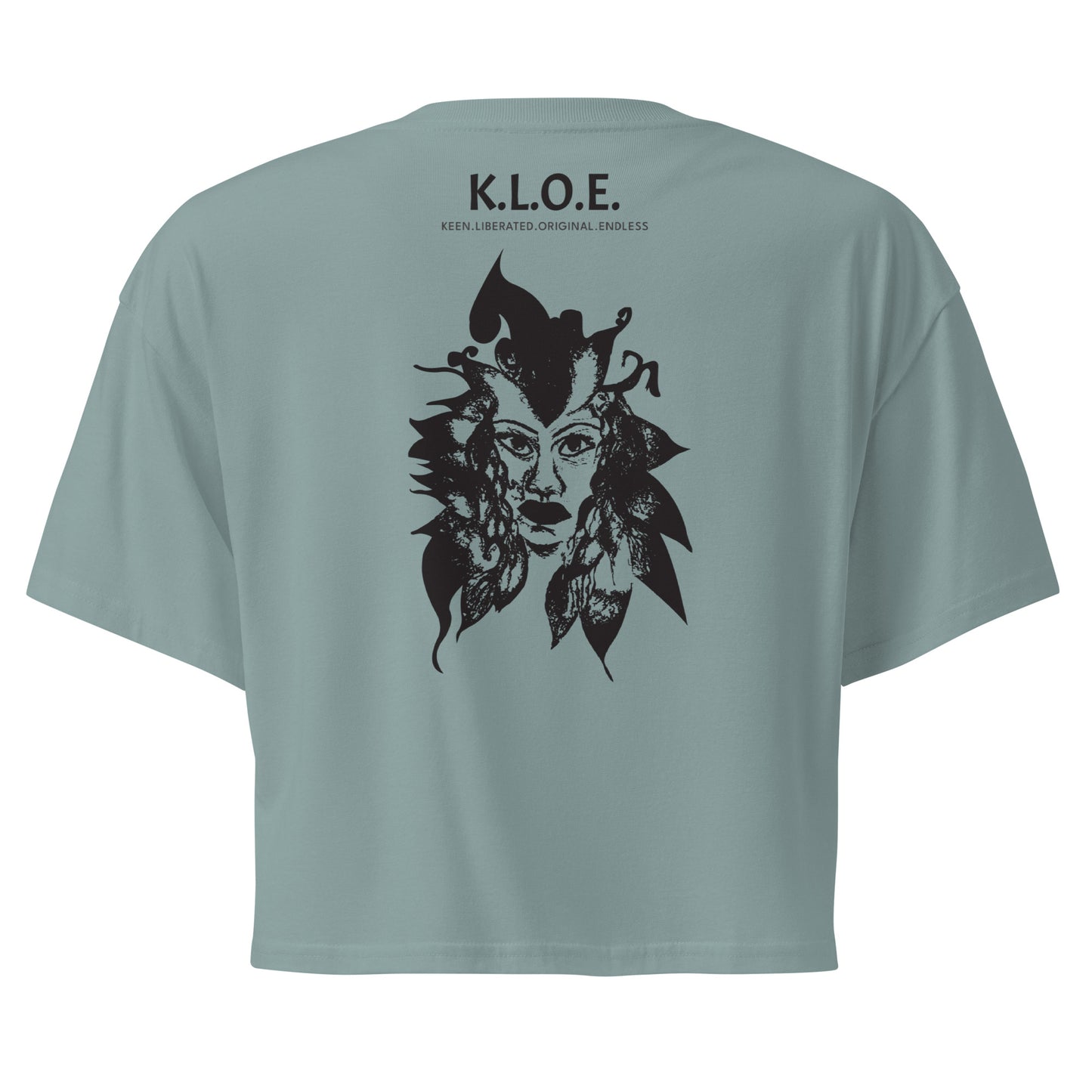 Back view of a mineral K.L.O.E. crop t-shirt showcasing a culturally inspired, hand-drawn black design featuring a bold, expressive face intertwined with flowing, abstract patterns, and K.L.O.E. logo, embodying artistic self-expression and modern bohemian style fashion.