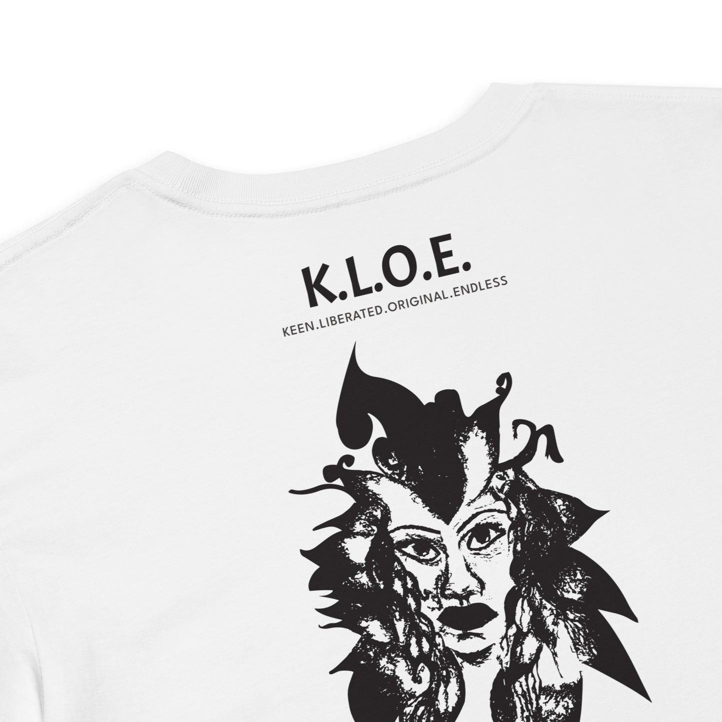 Detail view of a back view of a white K.L.O.E. crop t-shirt showcasing a culturally inspired, hand-drawn black design featuring a bold, expressive face intertwined with flowing, abstract patterns, and K.L.O.E. logo, embodying artistic self-expression and modern bohemian style fashion.