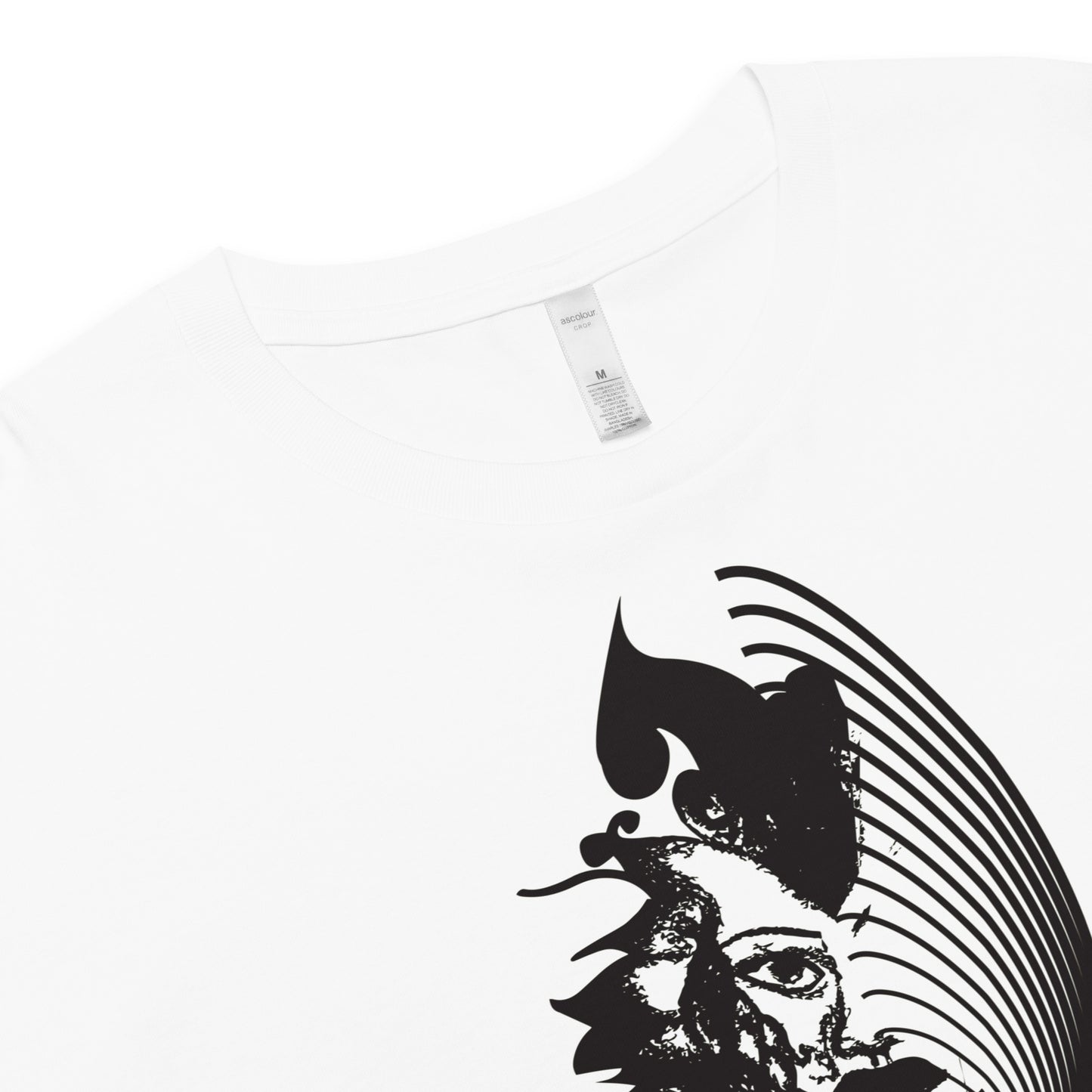 Detail view of a white K.L.O.E. crop t-shirt featuring a culturally inspired, hand-drawn black graphic of a bold, expressive face surrounded by intricate details, celebrating individuality and artistic self-expression in modern bohemian style fashion.