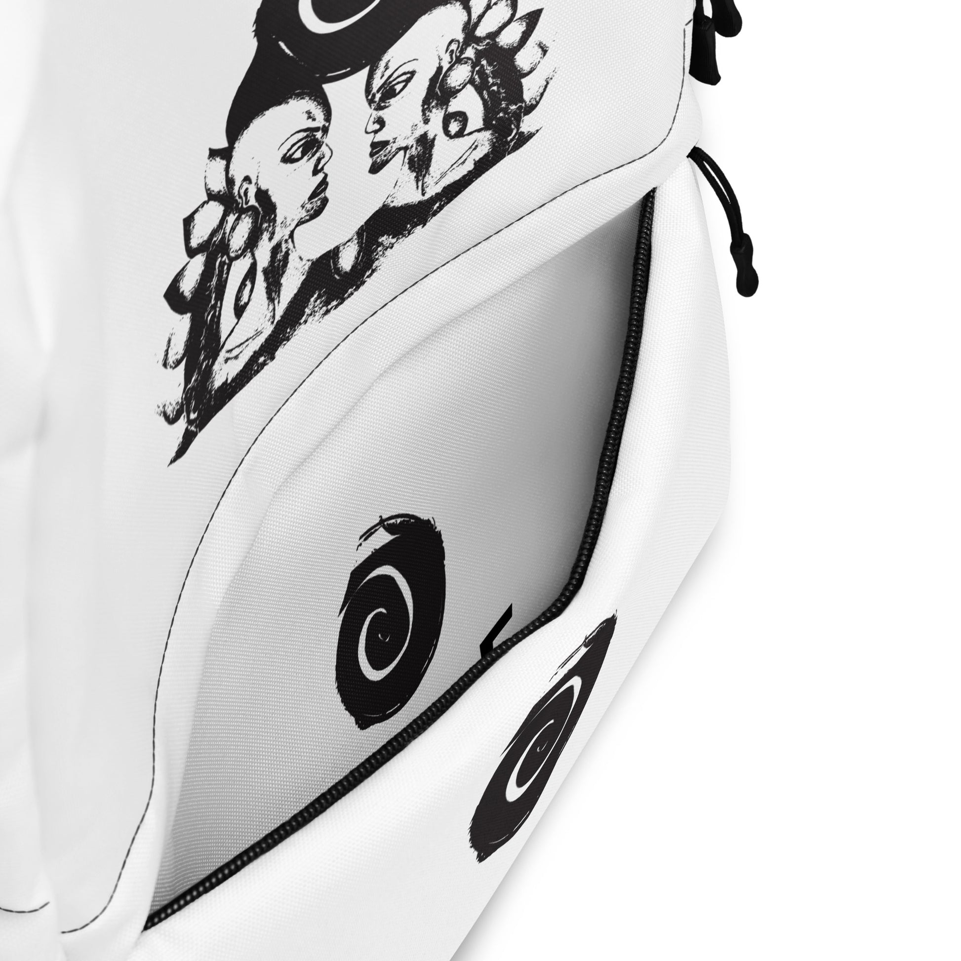 The inside pocket of the white backpack featuring a hand-drawn, culturally inspired design of two mirrored faces in bold black on the main panel, paired with a striking black spiral motif on the spacious front pocket, celebrating self-expression and individuality in modern bohemian style fashion by K.L.O.E.