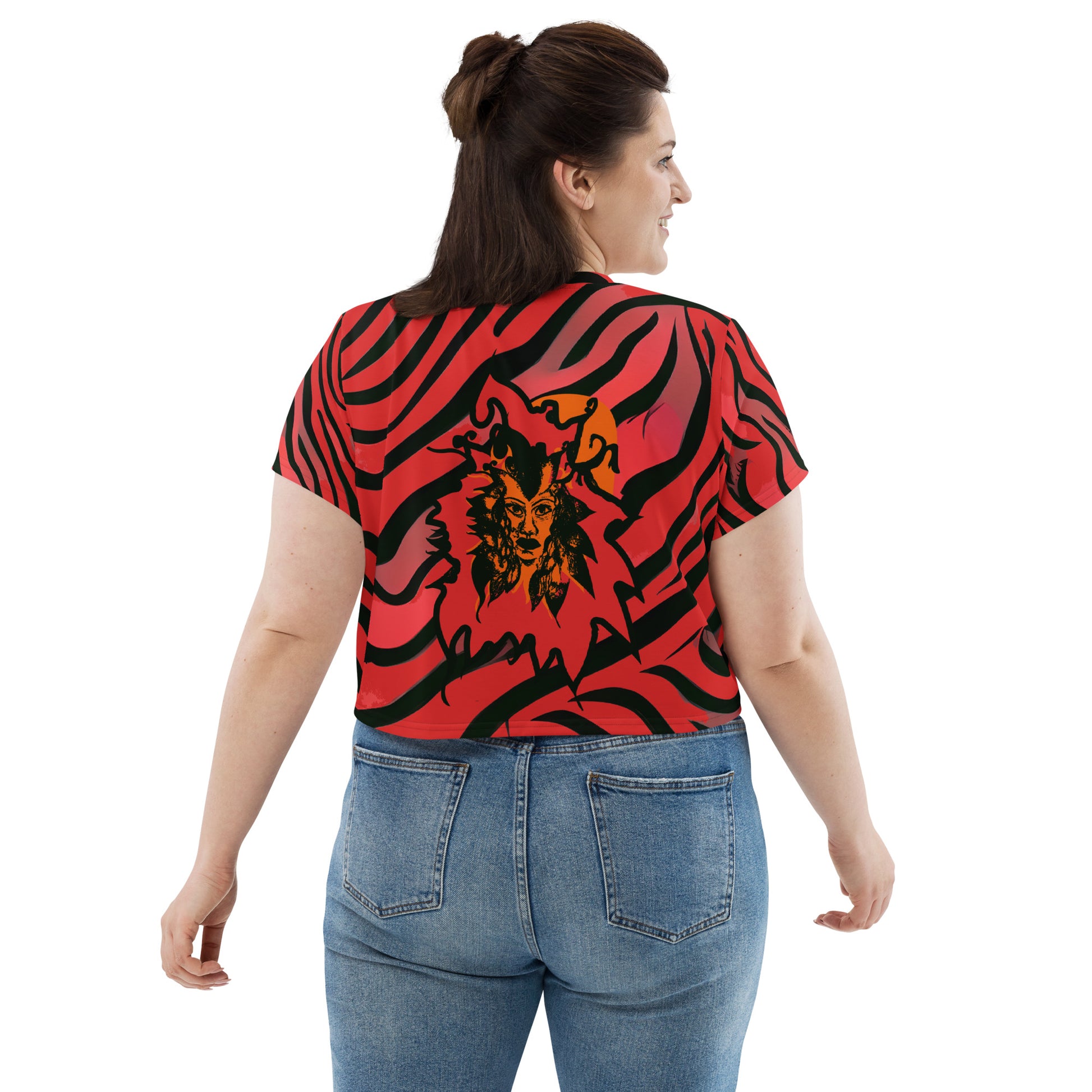 A model wearing bold red and black crop tee from Kloe Store featuring a striking artistic face design and abstract swirling patterns, showcasing trendy and edgy streetwear fashion, back view.