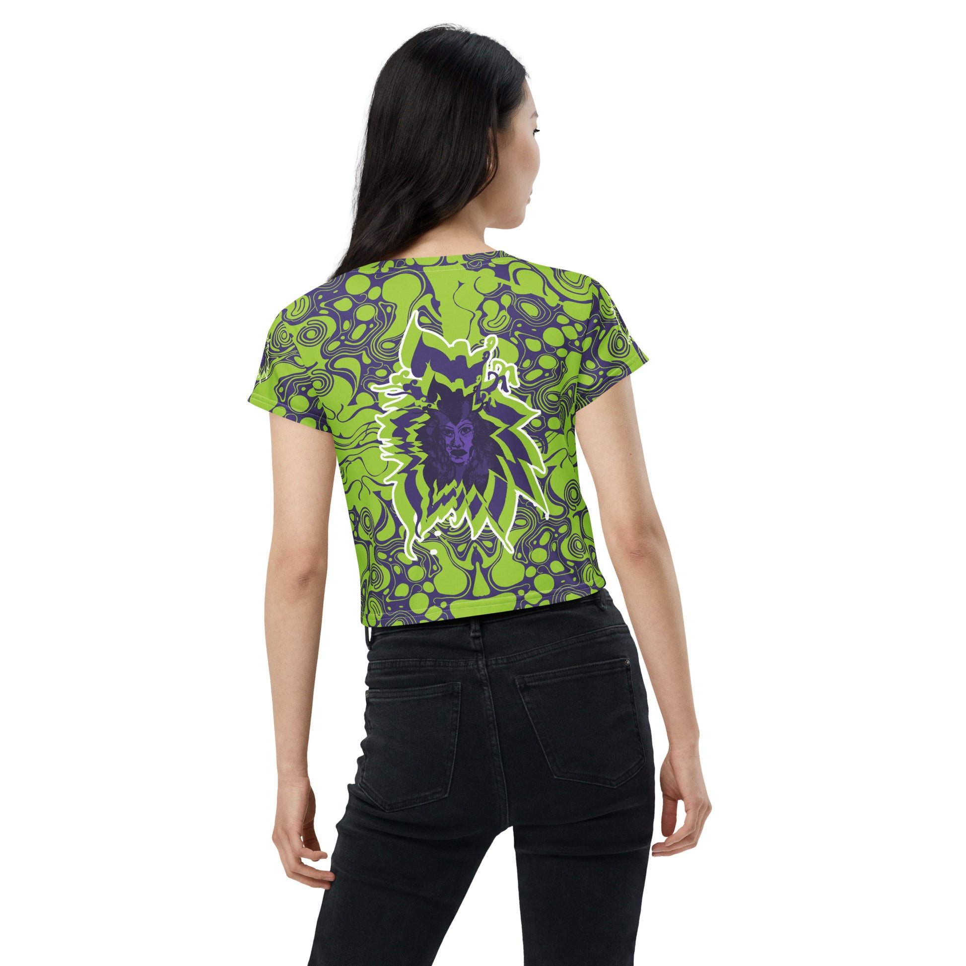 A model wearing green and purple crop tee from Kloe Store featuring bold abstract patterns and a unique central artistic face design, perfect for a trendy and edgy streetwear style.