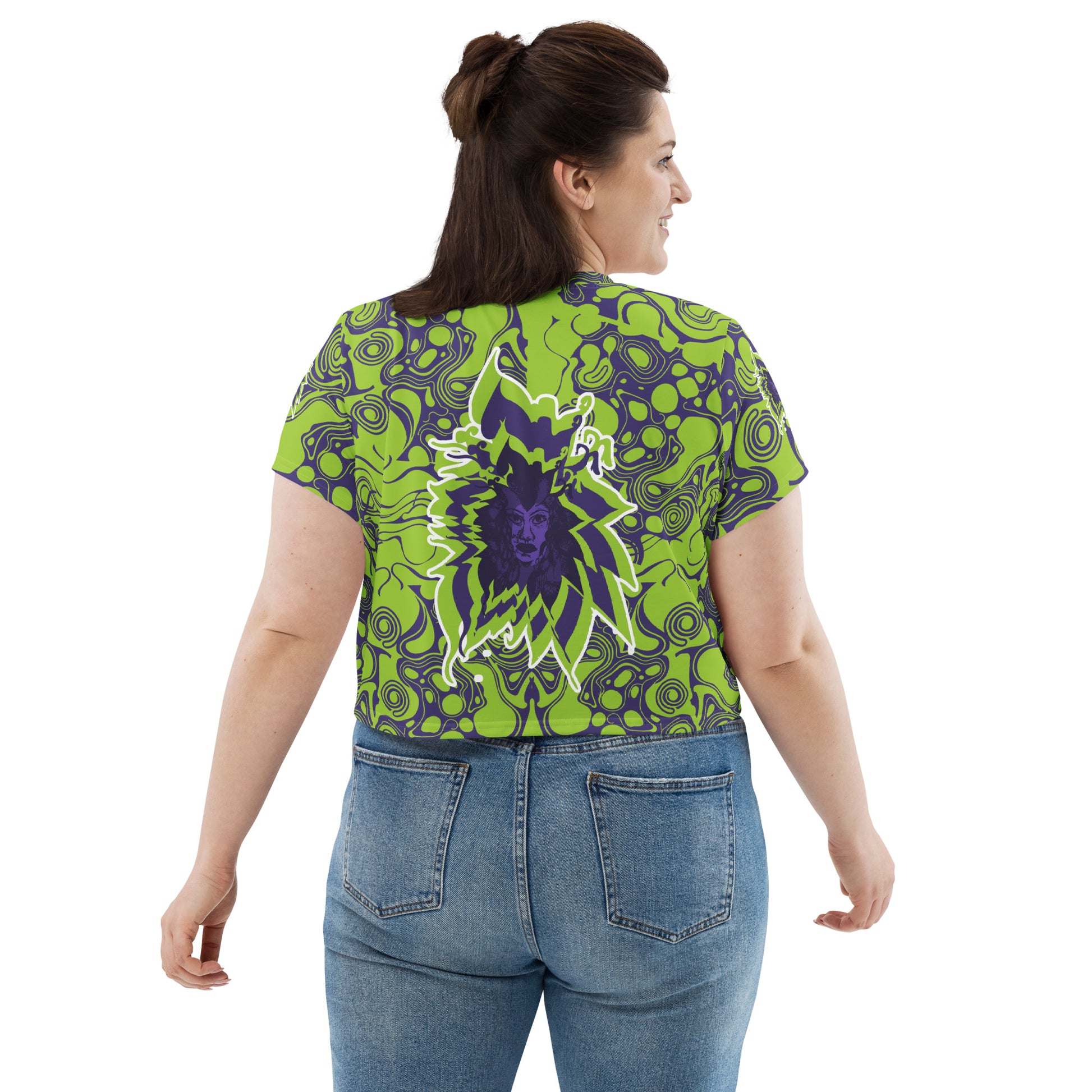 A model wearing green and purple crop tee from Kloe Store featuring bold abstract patterns and a unique central artistic face design, perfect for a trendy and edgy streetwear style.