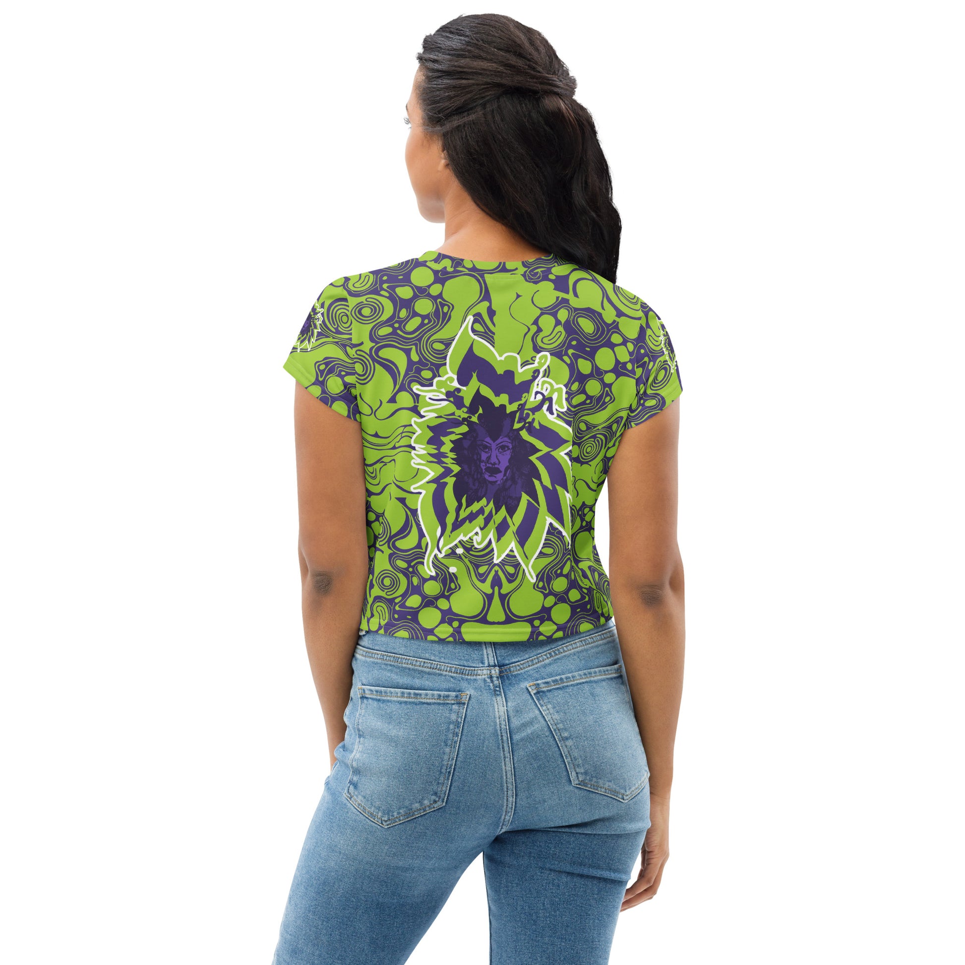 A model wearing green and purple crop tee from Kloe Store featuring bold abstract patterns and a unique central artistic face design, perfect for a trendy and edgy streetwear style.