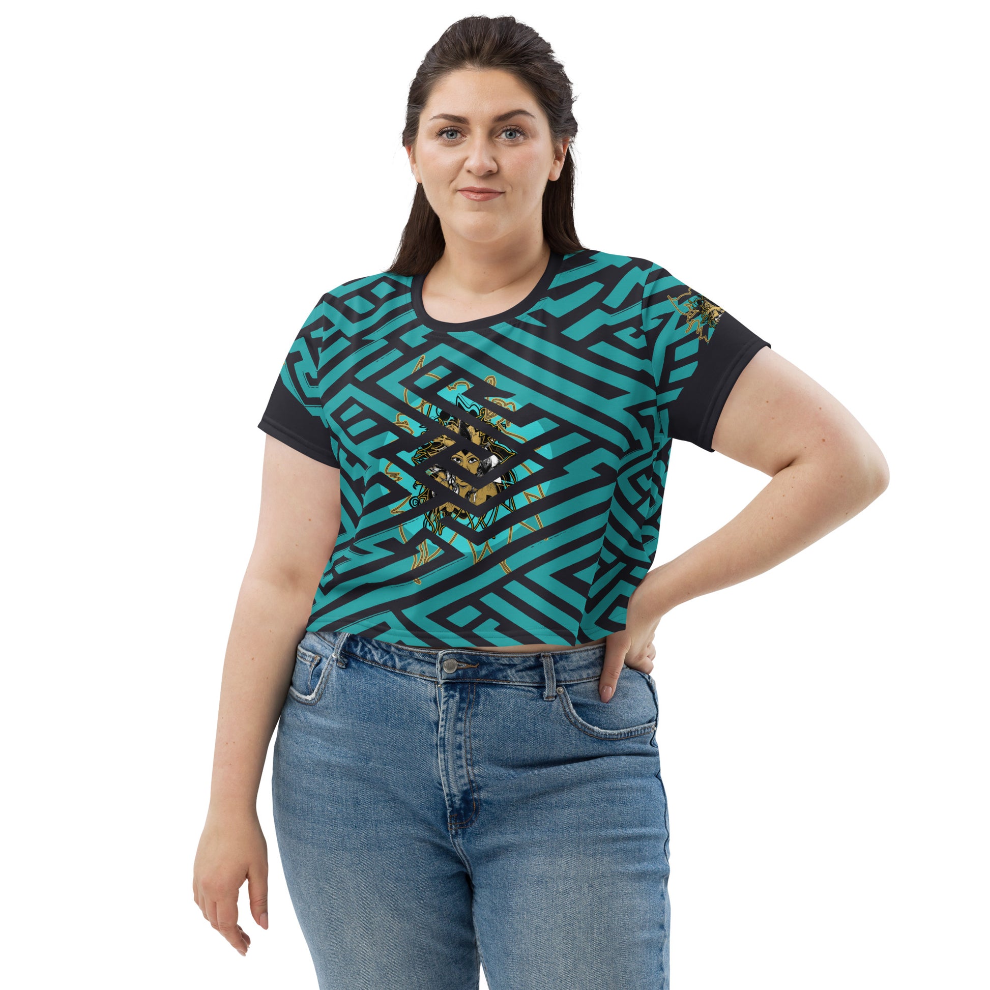 Front view of a vibrant blue and black geometric patterned crop top with a bold graphic centerpiece, worn by plus size model.