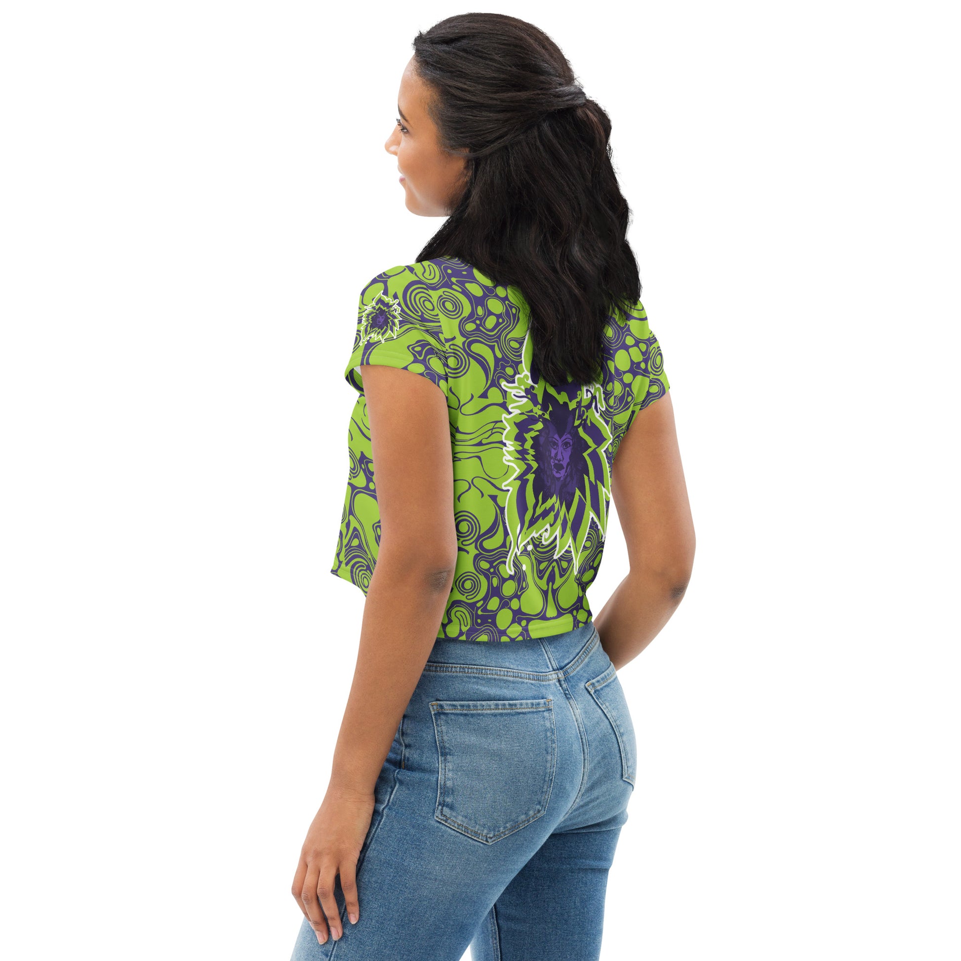 A model wearing green and purple crop tee from Kloe Store featuring bold abstract patterns and a unique central artistic face design, perfect for a trendy and edgy streetwear style.