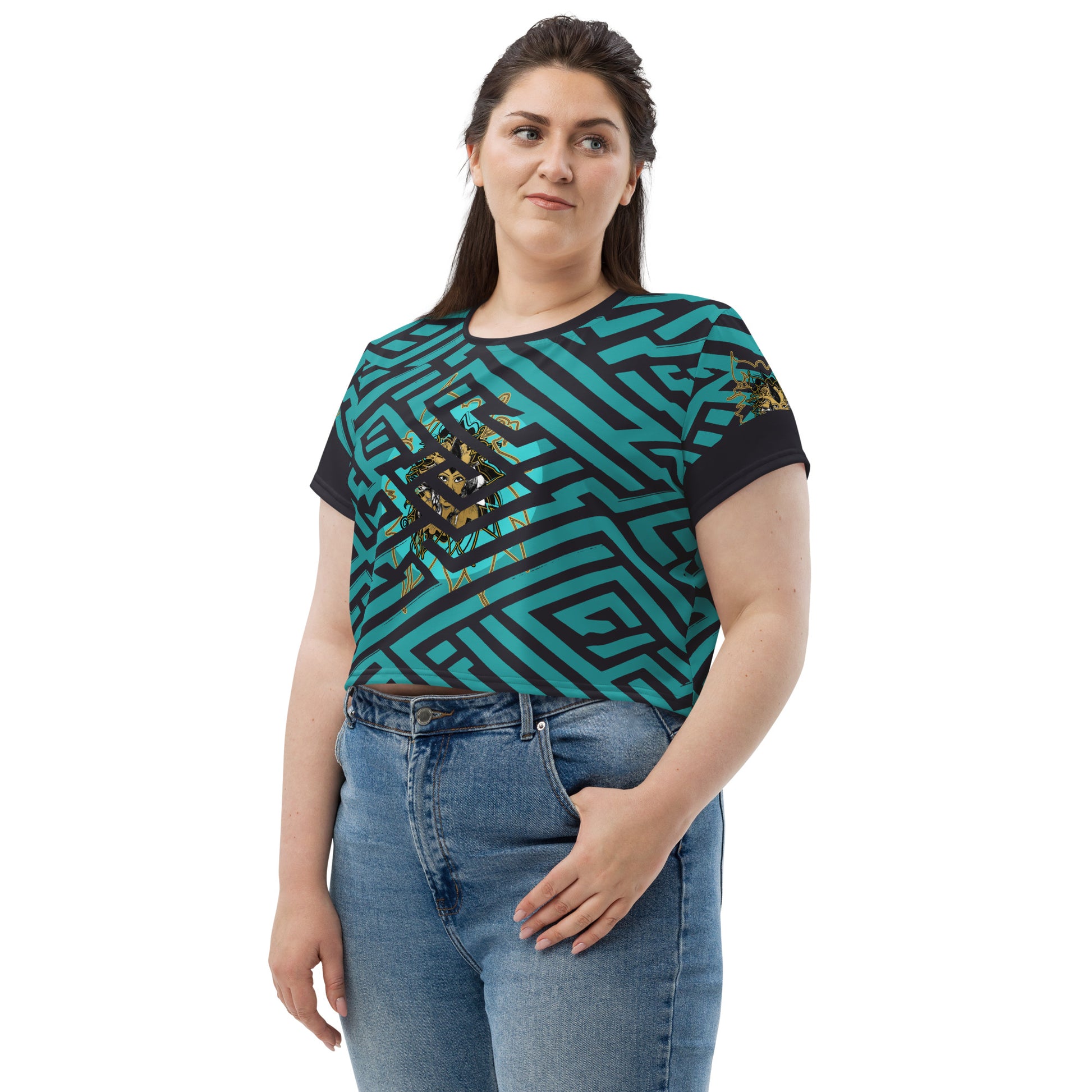 Front view of a vibrant blue and black geometric patterned crop top with a bold graphic centerpiece, plus size model.