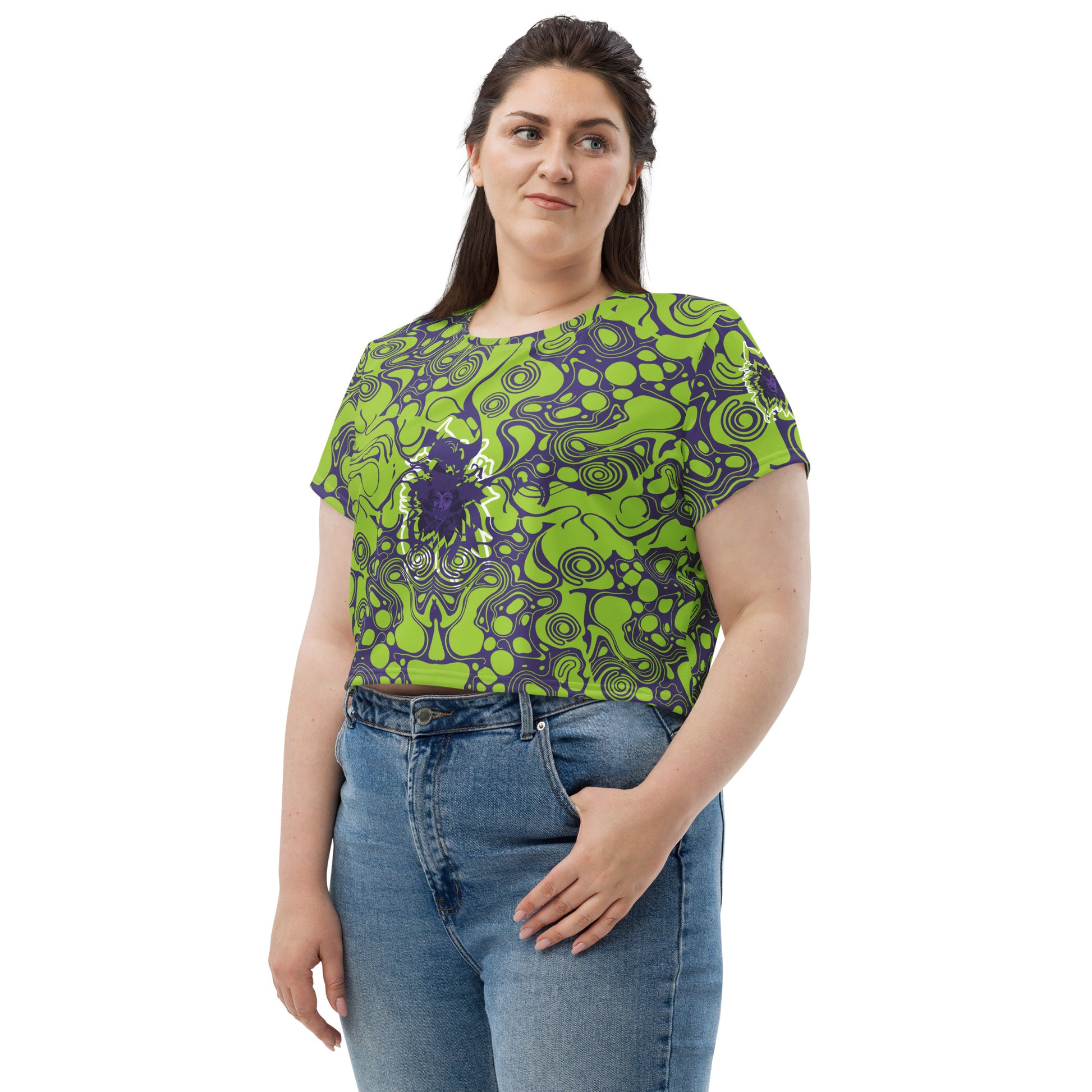 A model wearing green and purple crop tee from Kloe Store featuring bold abstract patterns and a unique central artistic face design, perfect for a trendy and edgy streetwear style.