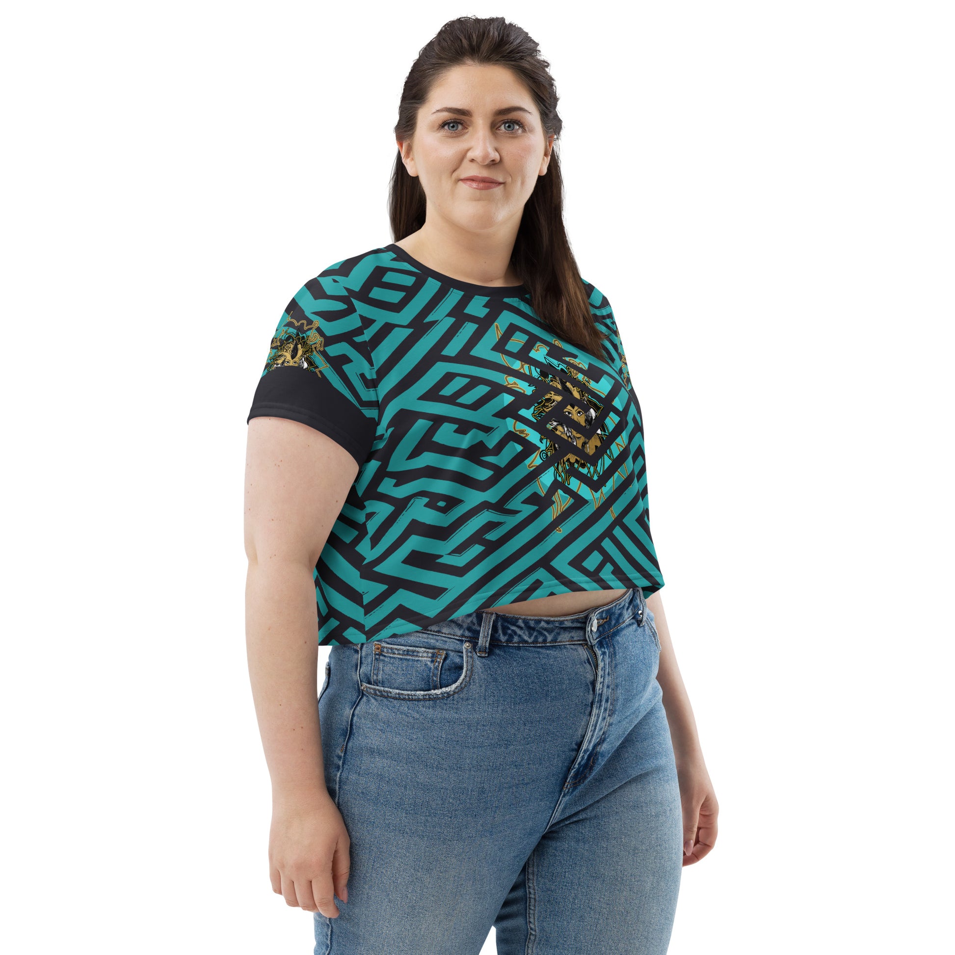 Front view of a vibrant blue and black geometric patterned crop top with a bold graphic centerpiece, plus size model.