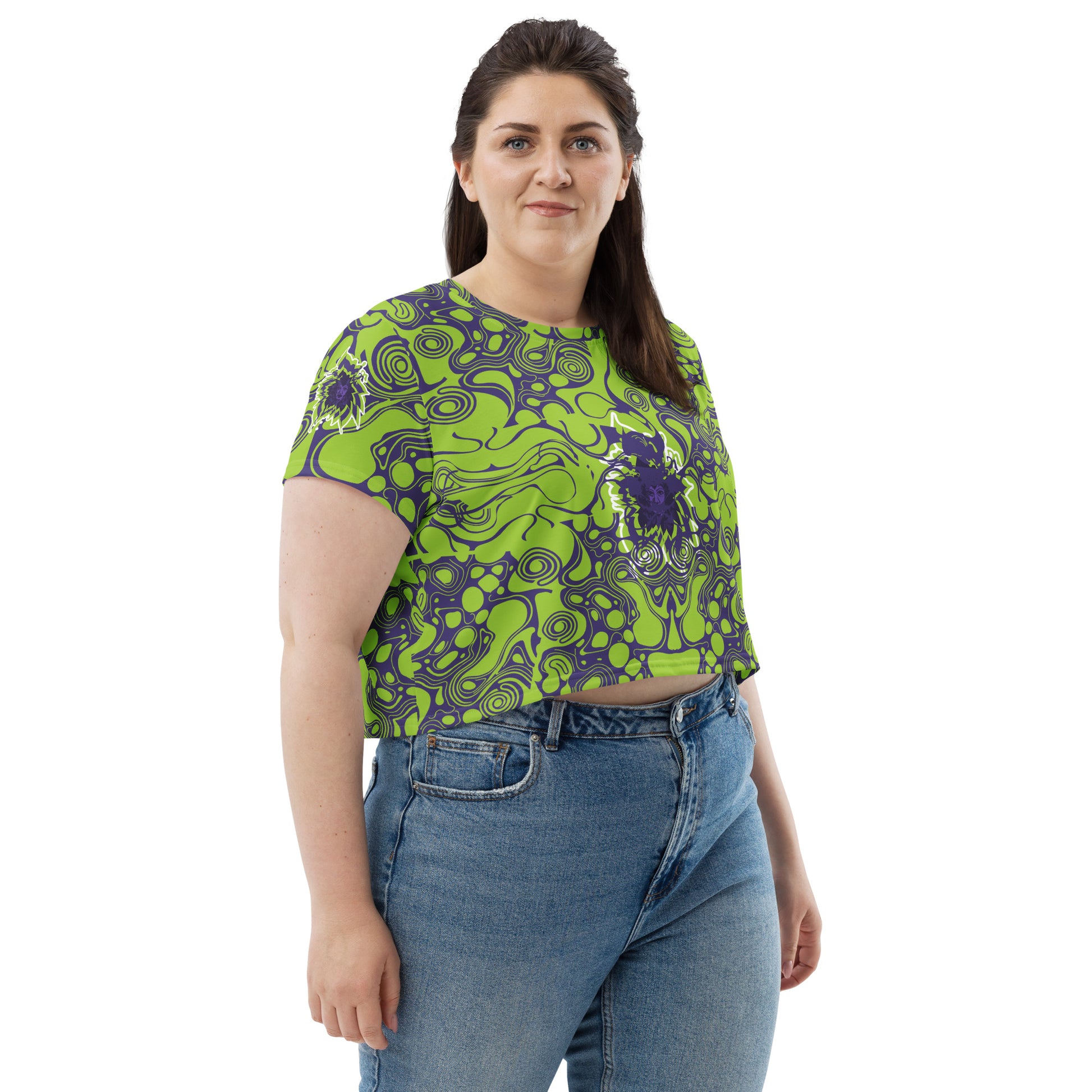 A model wearing green and purple crop tee from Kloe Store featuring bold abstract patterns and a unique central artistic face design, perfect for a trendy and edgy streetwear style.