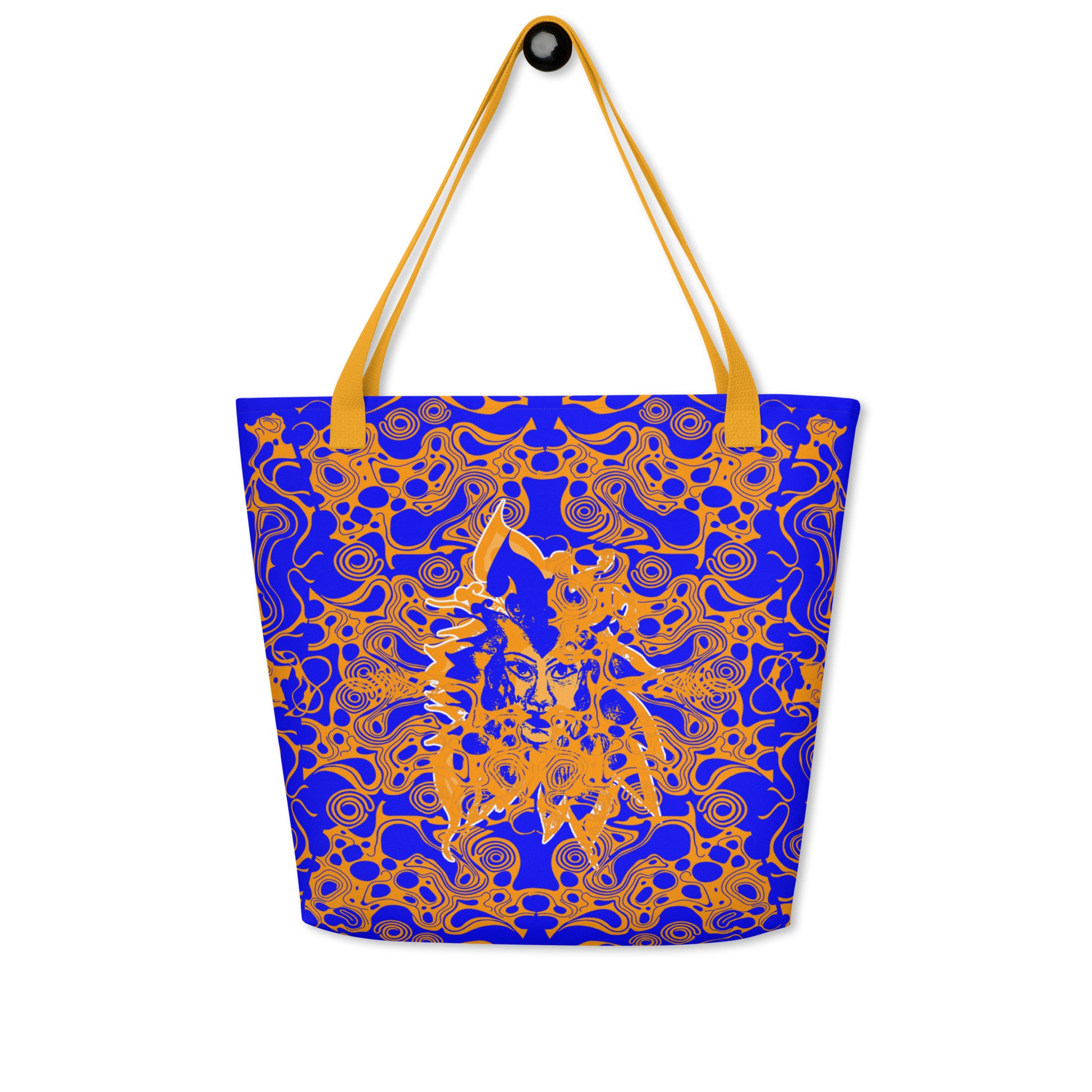 Bold blue and orange tote bag from Kloe Store featuring intricate abstract patterns and a central artistic face design, offering a stylish and edgy streetwear look.
