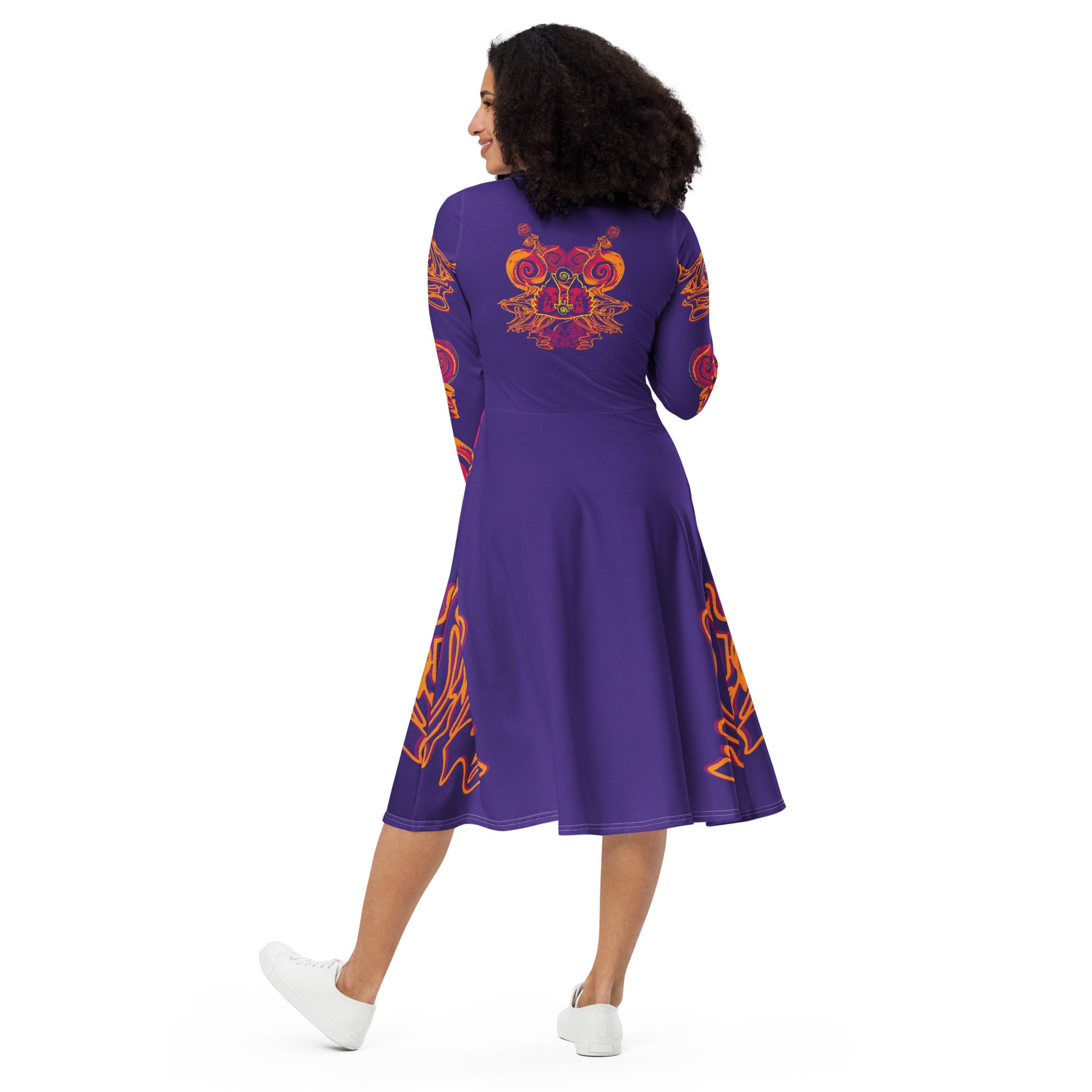 Bold purple long sleeve dress with vibrant orange and red culturally inspired patterns, featuring mirrored face design and swirling motifs — expressive fashion from KLOE’s The Secret Chambers of I & I collection, on a model.