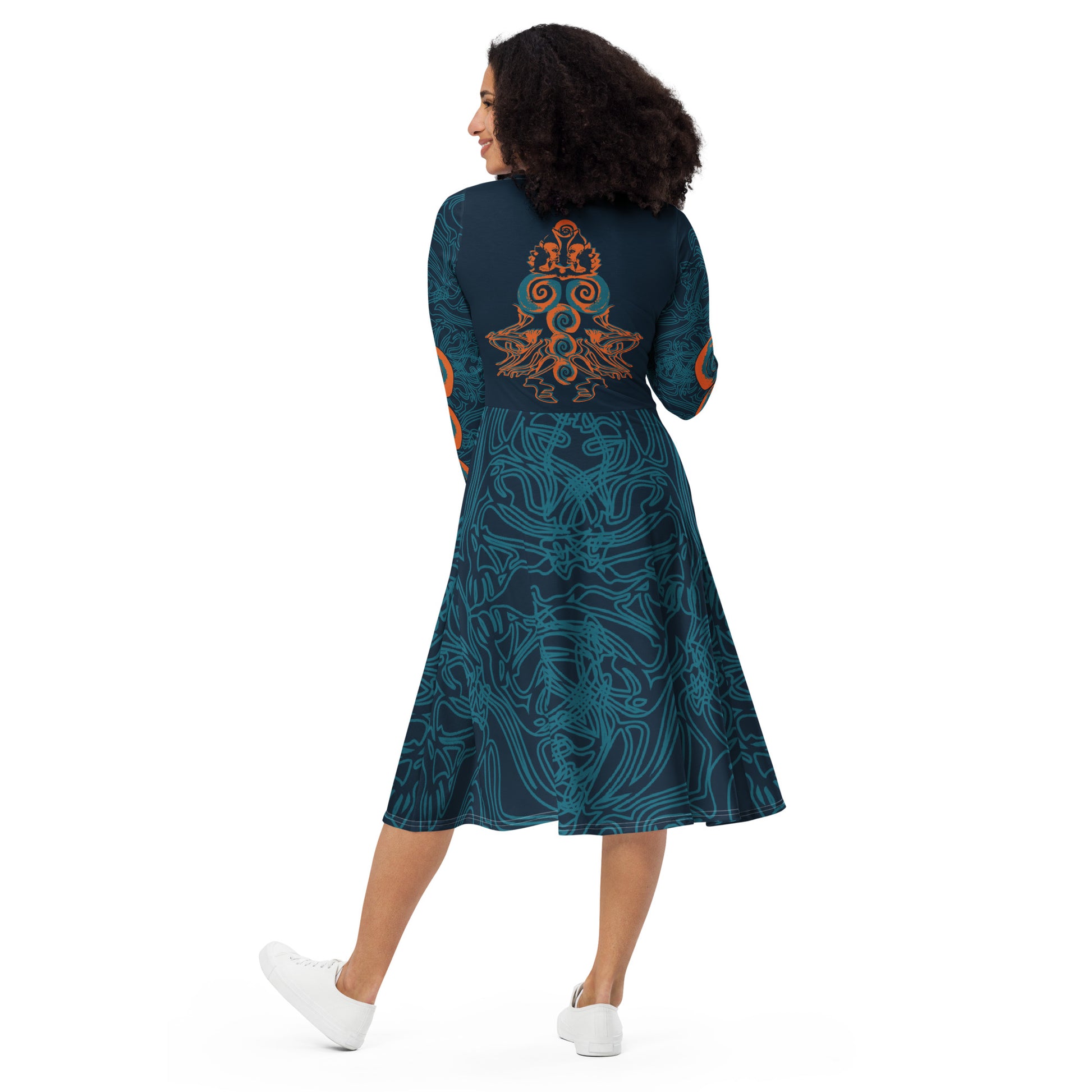 Back view of a navy blue long-sleeve dress featuring intricate cyan patterns, an orange mirrored face motif, and a flowing fit-and-flare silhouette.