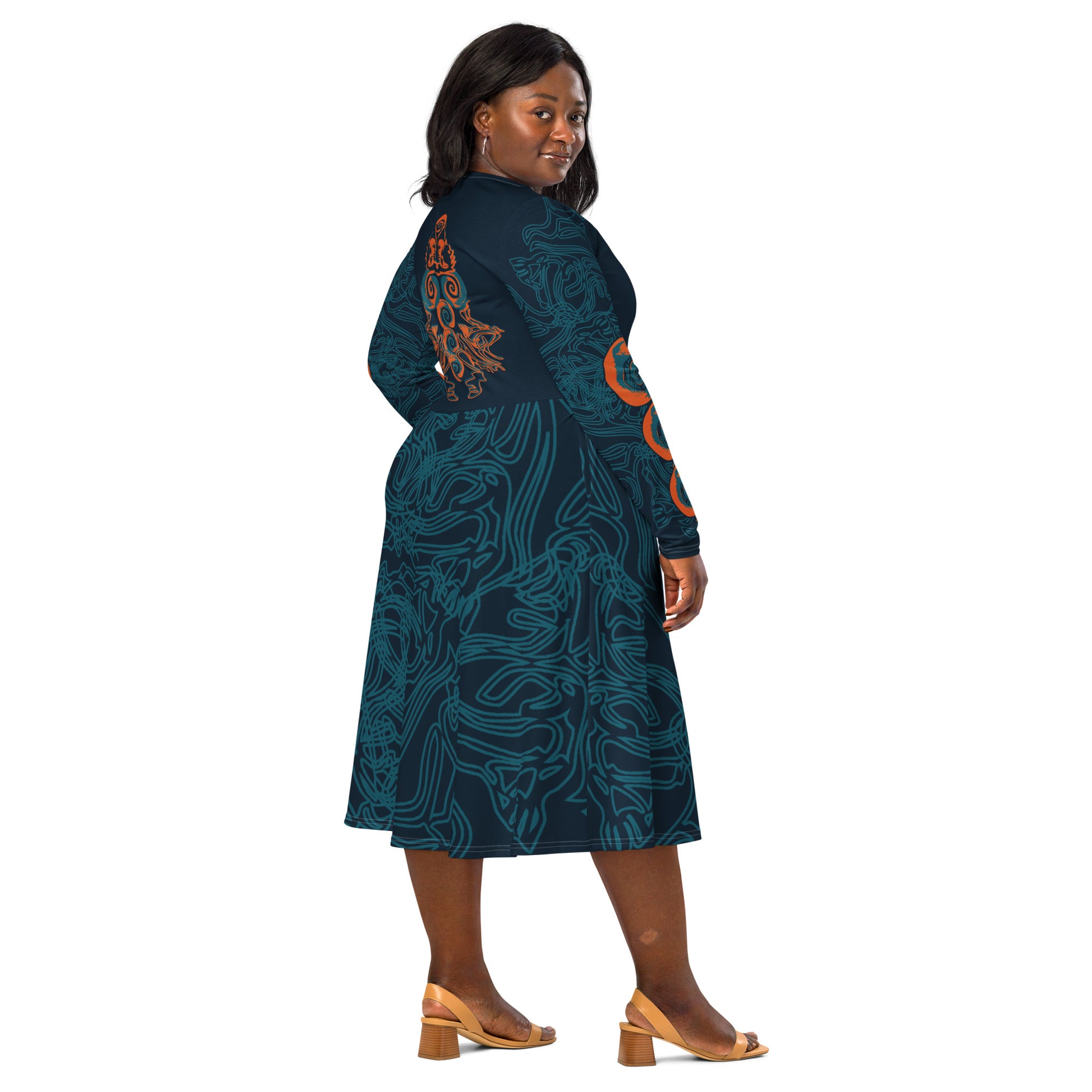 Back view of a navy blue long-sleeve dress featuring intricate cyan patterns, an orange mirrored face motif, and a flowing fit-and-flare silhouette.