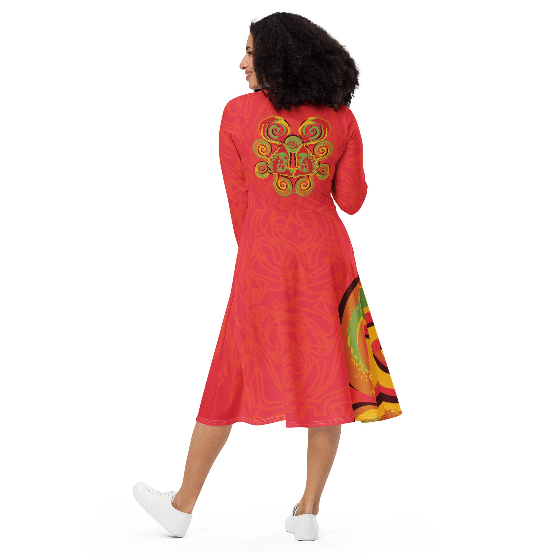 Red dress with vibrant swirl  details and mirrored face design on the back, inspired by cultural art and bold self-expression.