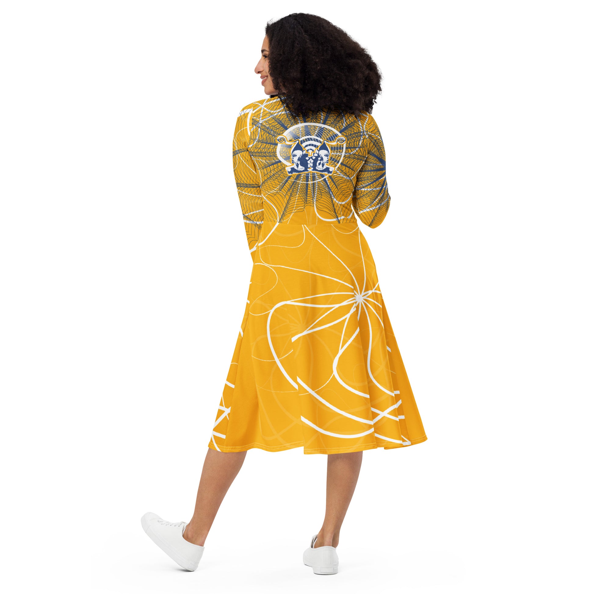 Back view of a golden yellow midi dress with navy web-style graphics and a mirrored face emblem across the upper back, combining cultural artistry with modern silhouette from the Secret Chambers of I and I collection.