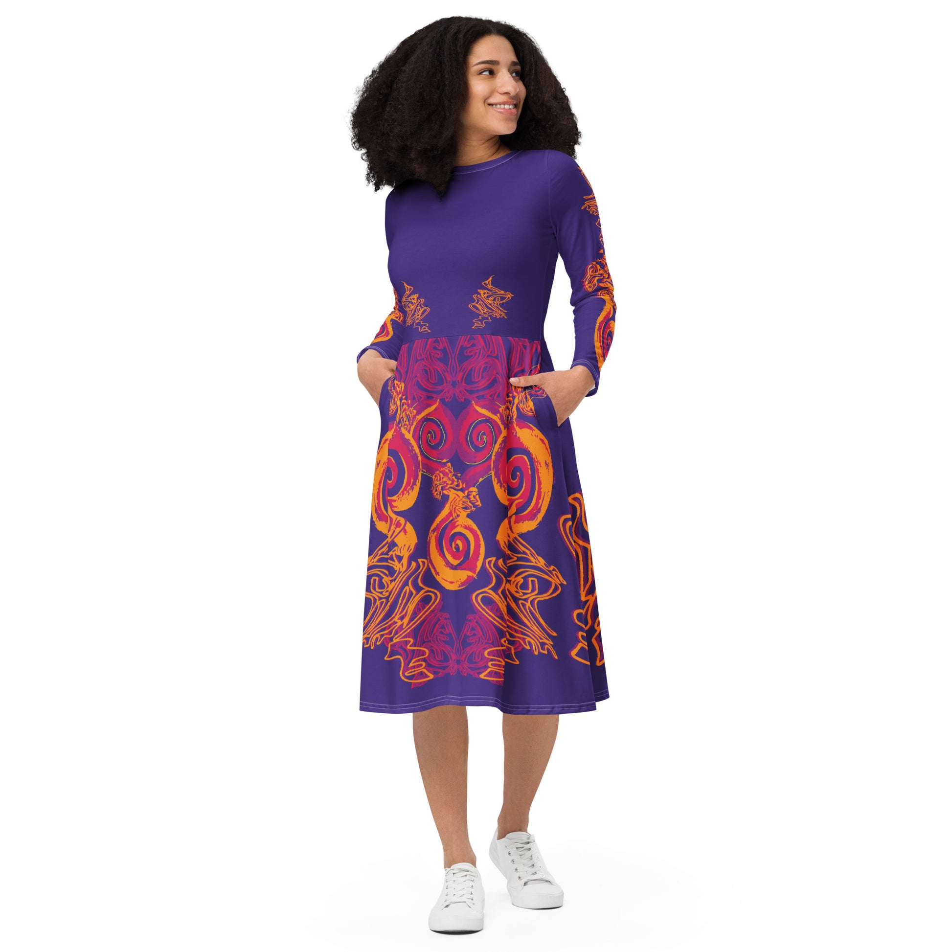 Bold purple long sleeve dress with vibrant orange and red culturally inspired patterns, featuring mirrored face design and swirling motifs — expressive fashion from KLOE’s The Secret Chambers of I & I collection, on a model.
