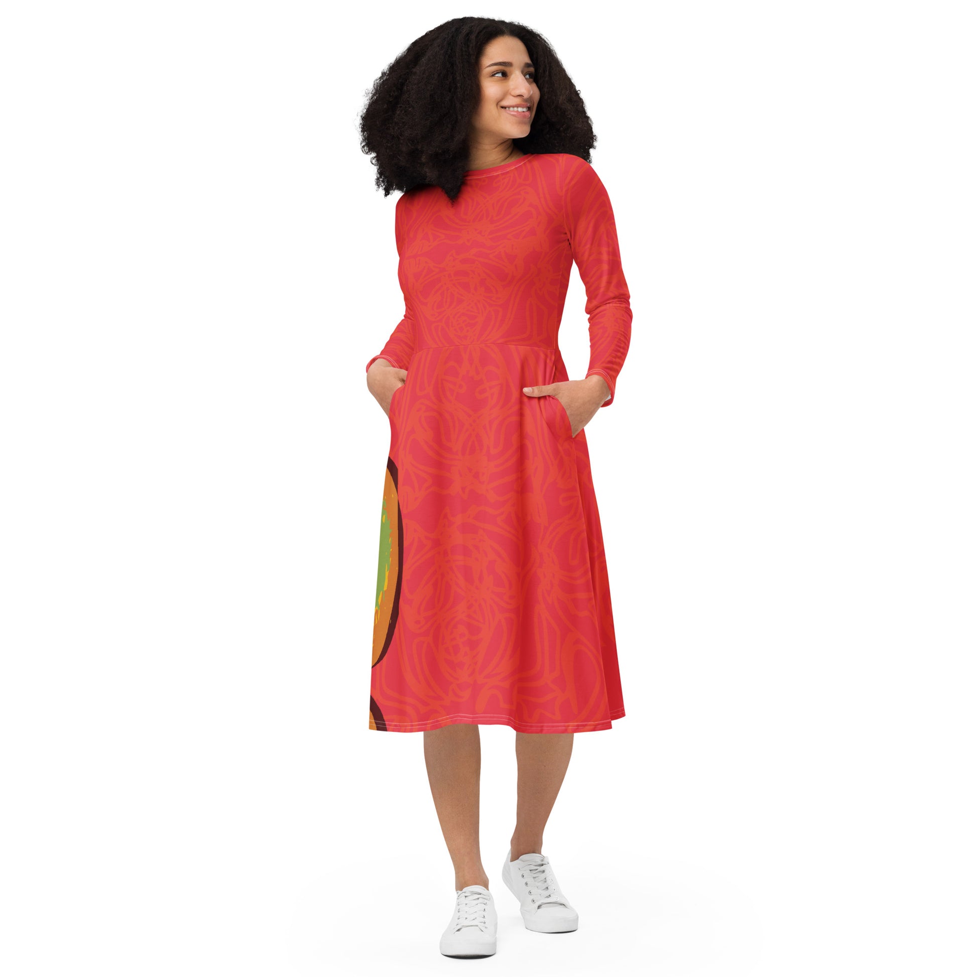 Red dress with vibrant swirl  details and mirrored face design on the back, inspired by cultural art and bold self-expression.